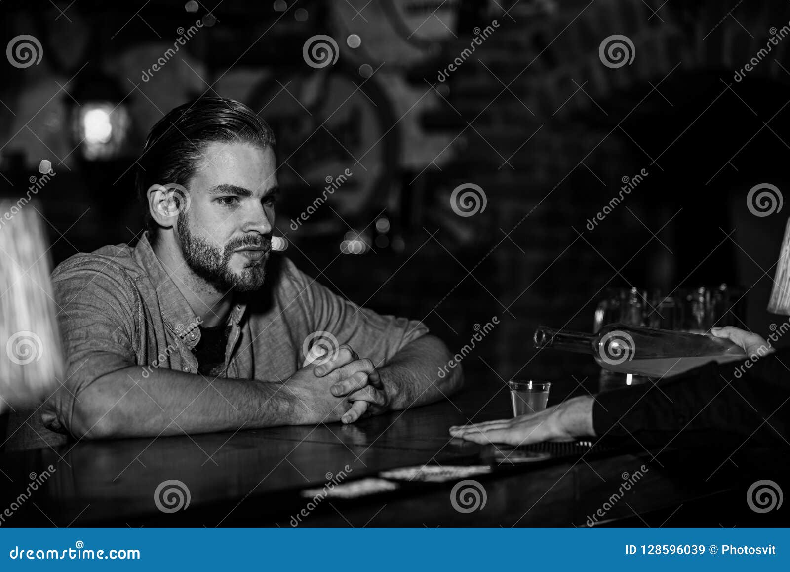 Man with Beard Sits at Bar Counter on Pub Background. Stock Image ...