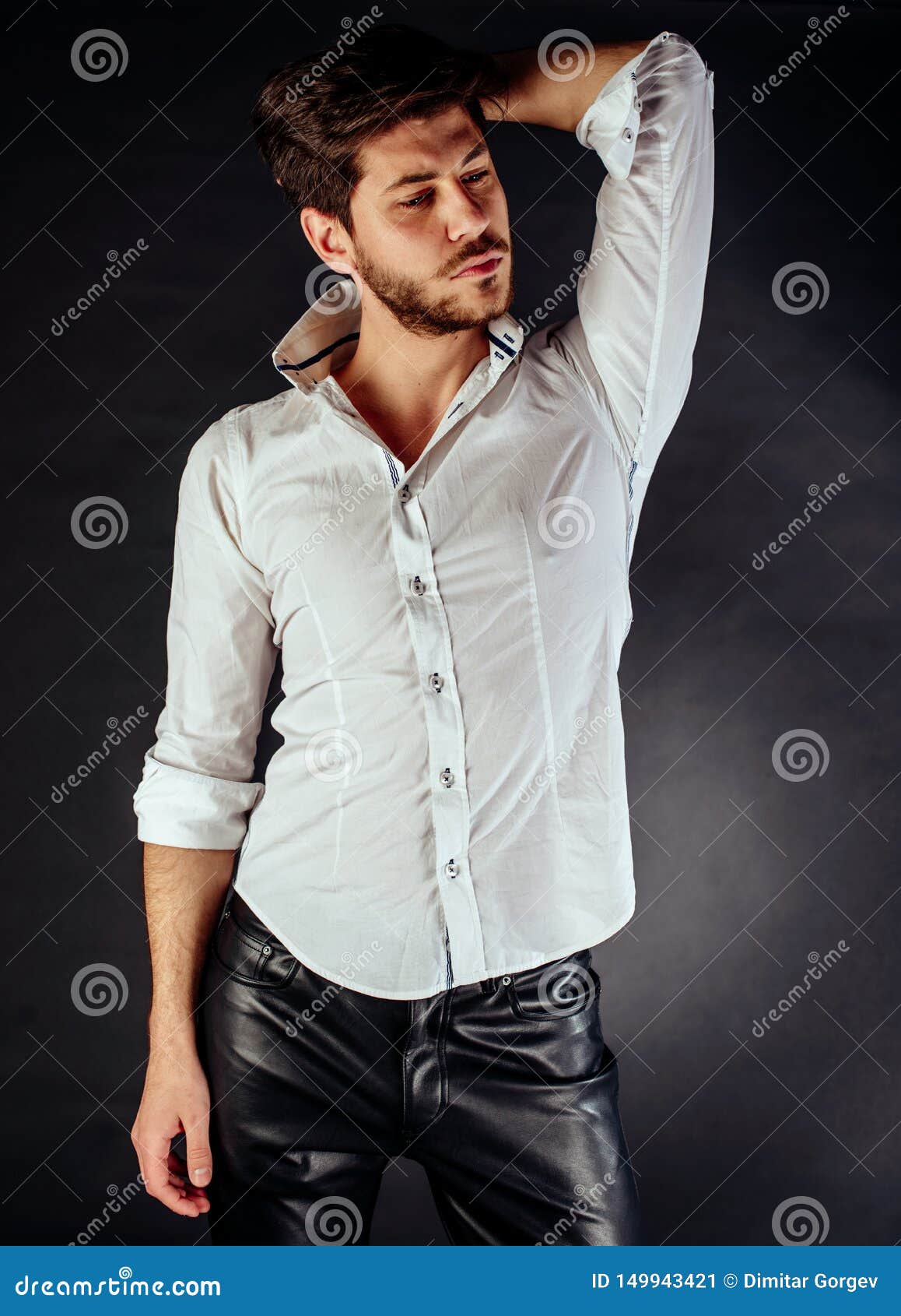 Young Man Standing and Looking Forward. Dark Background Stock Image ...