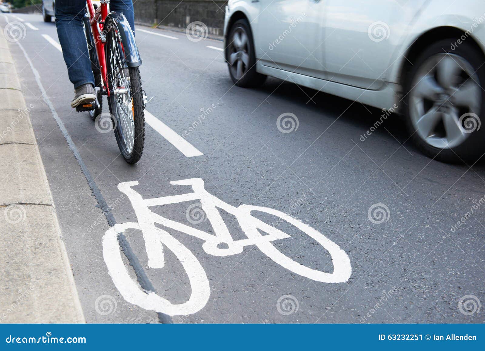man on bike using cycle lane as traffic speeds past