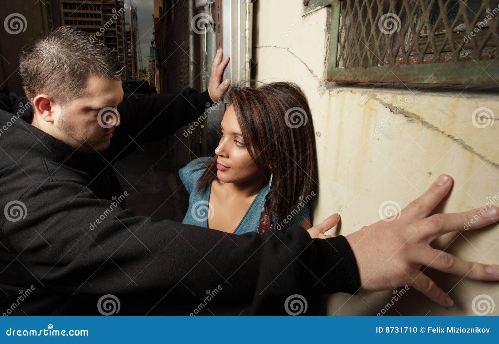 man blocking woman