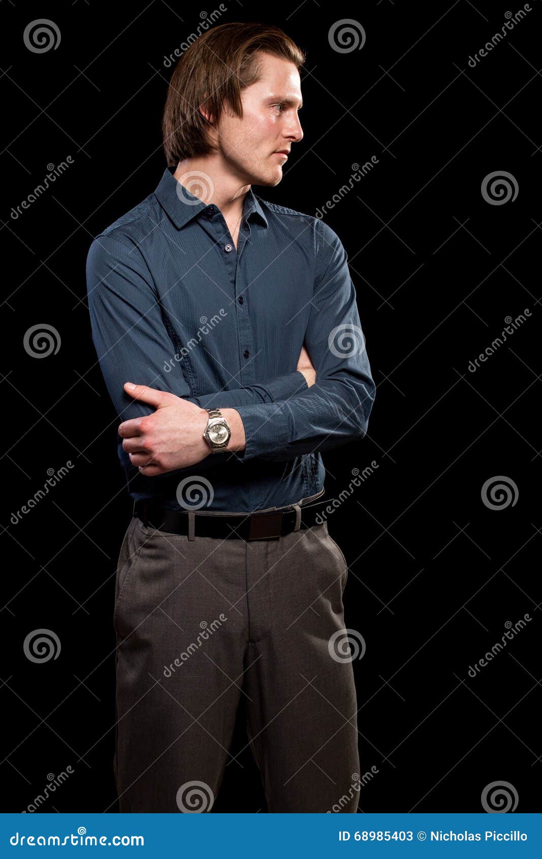 man in blue shirt and grey slacks