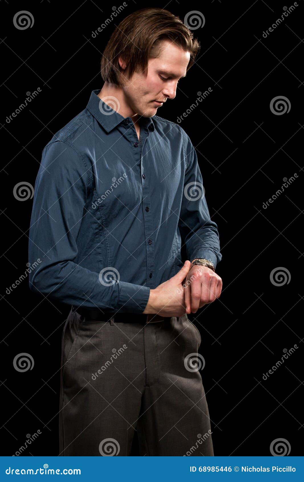 man in blue shirt and grey slacks