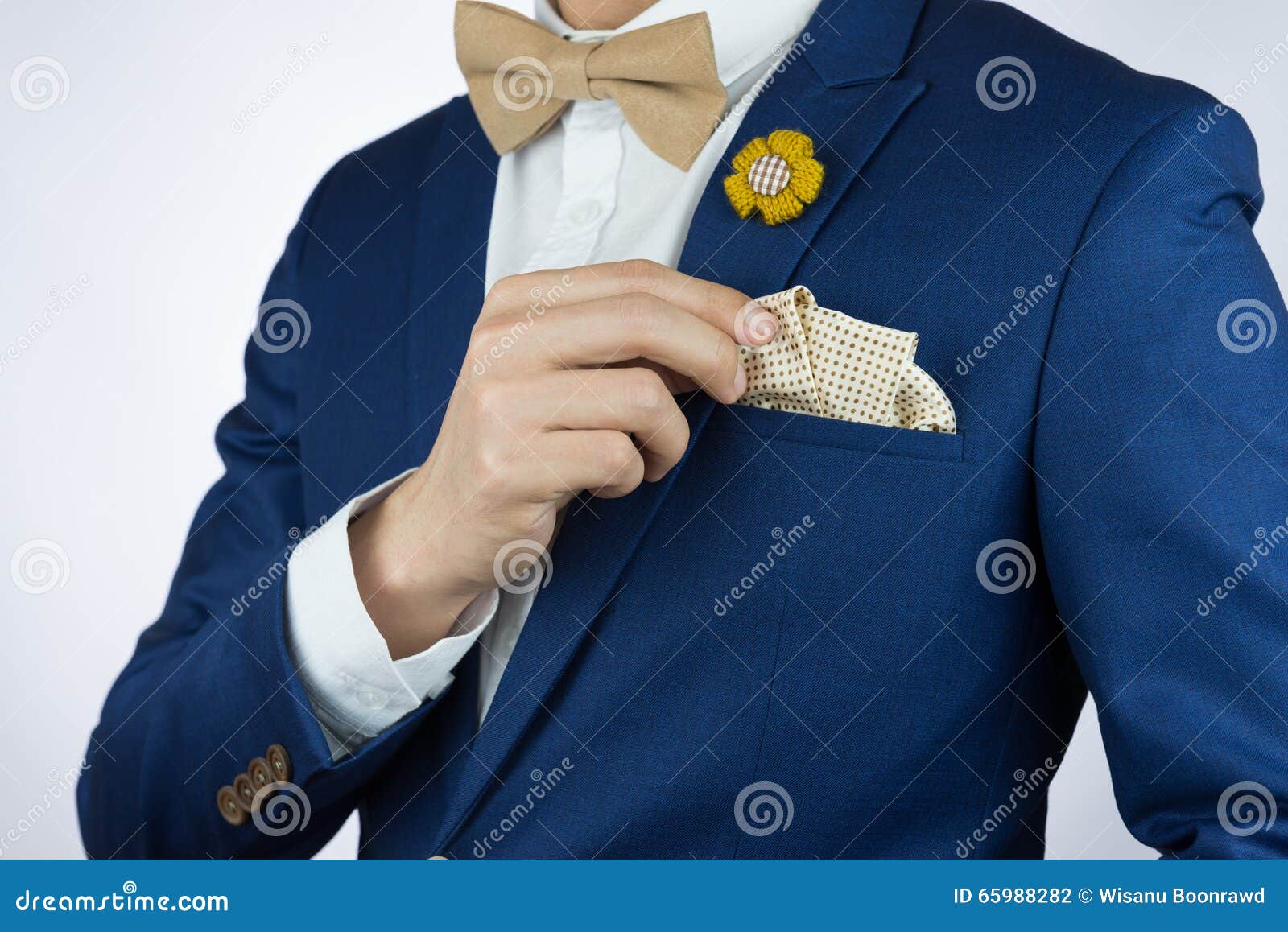 man blue suit bowtie, brooch, pocket square