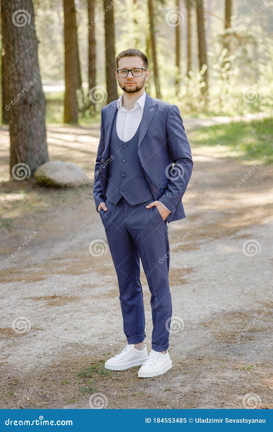 man blue suit white sneakers posing forest young man blue suit white sneakers posing forest 184553485