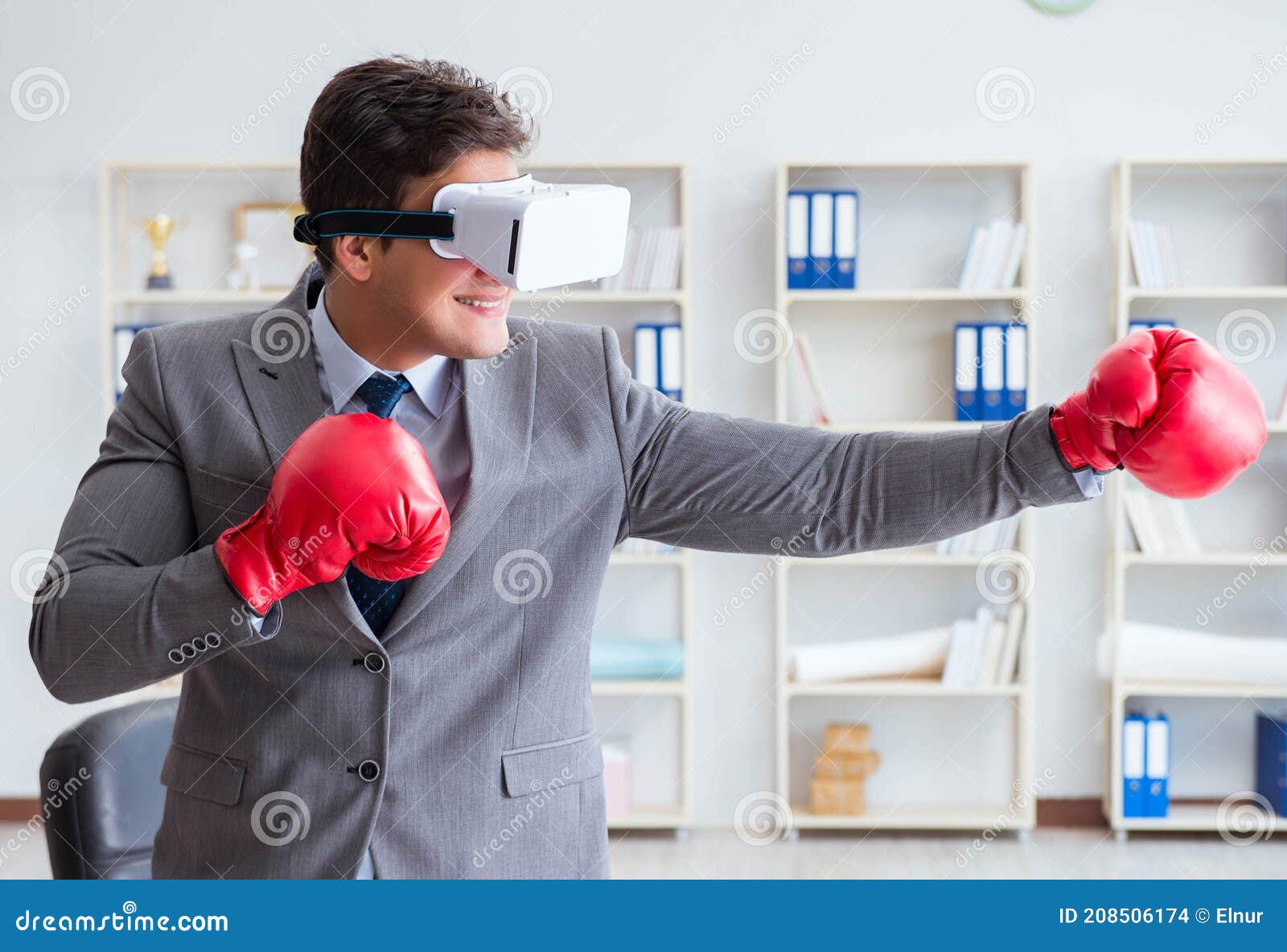 Man Boxing in the Office with Virtual Reality Goggles Stock Photo