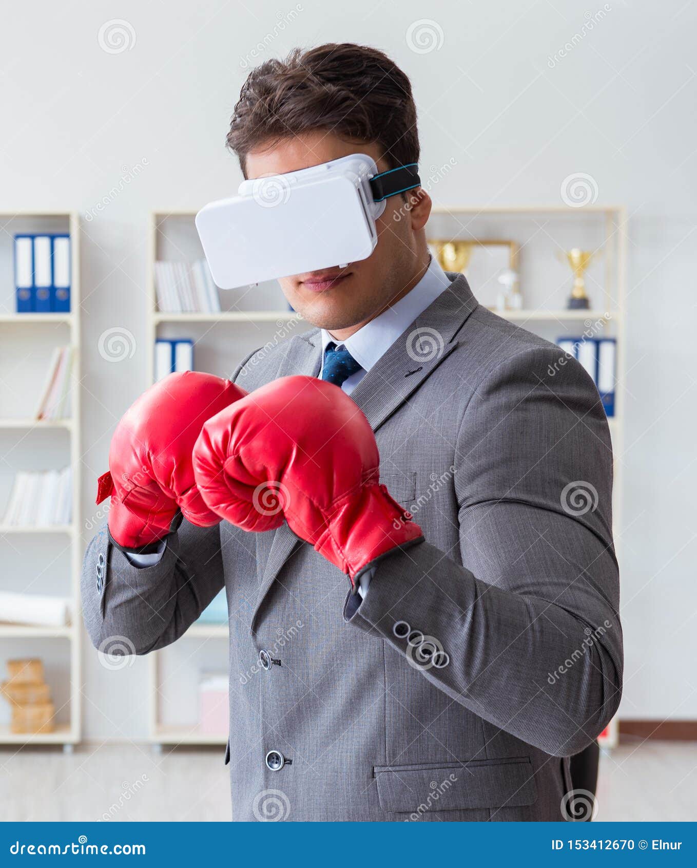 Man Boxing in the Office with Virtual Reality Goggles Stock Photo
