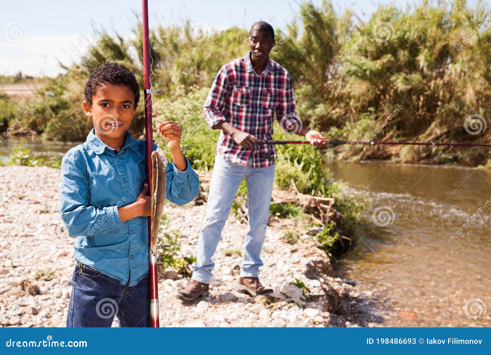 Man and Boy Holding Fish on Rod Stock Image - Image of leisure, coast:  198486693