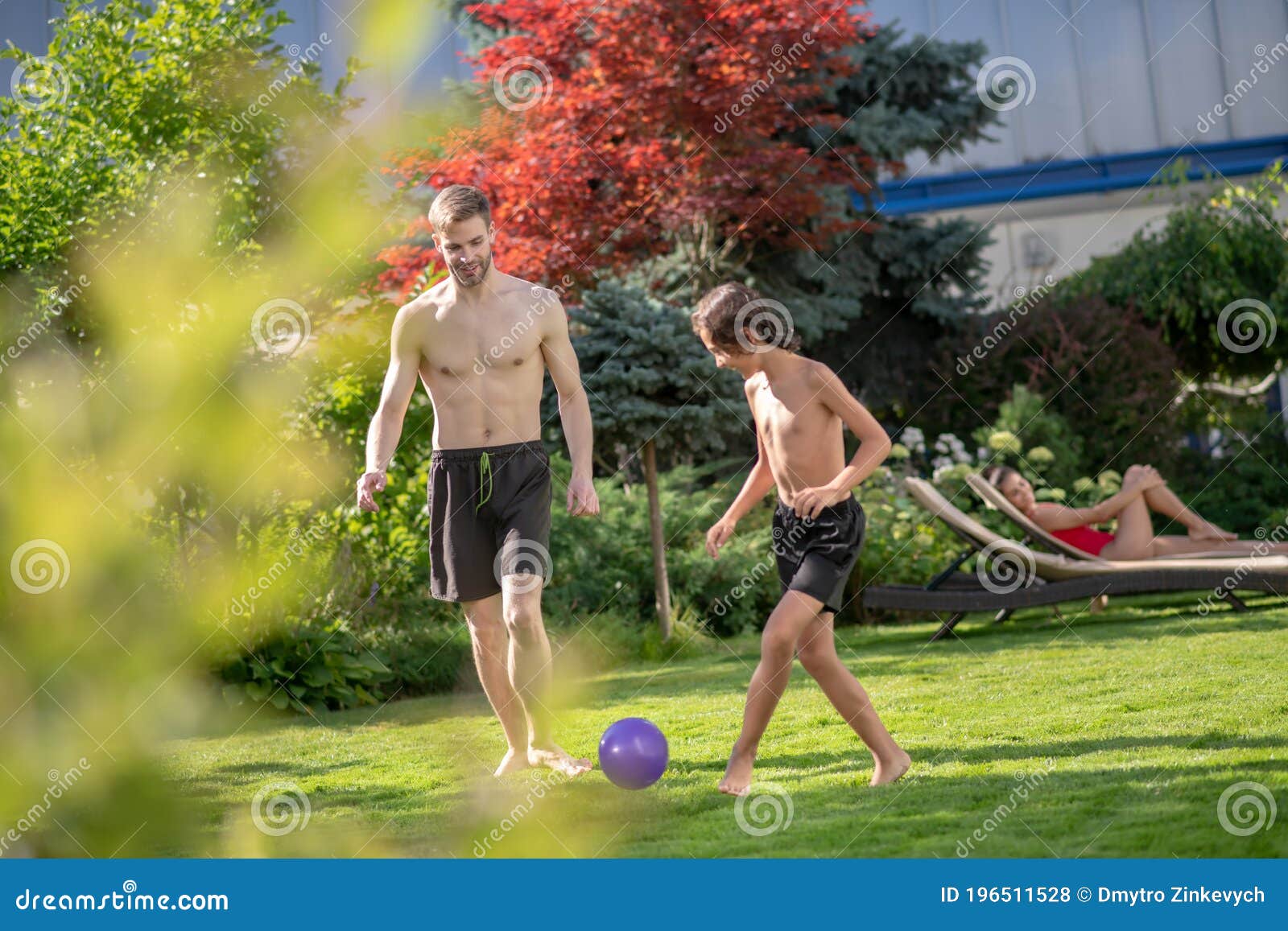 Man and Boy Playing with Ball on Grass Stock Photo Image of
