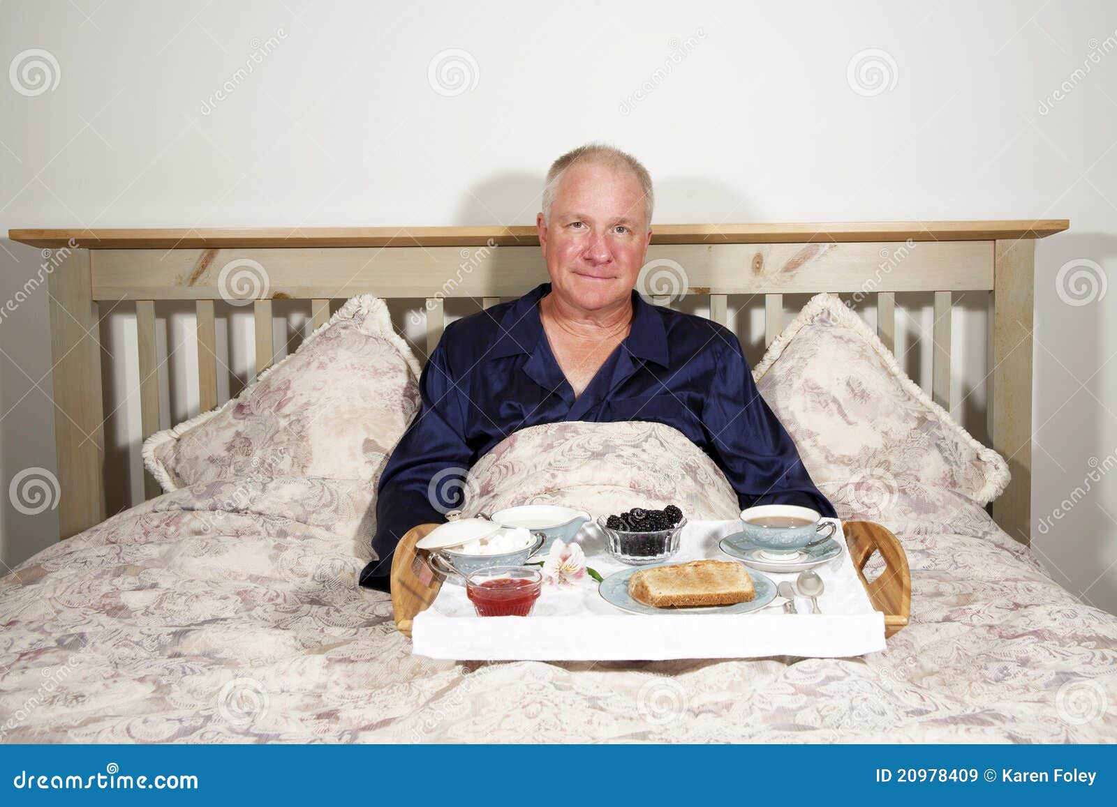 Man with Breakfast in Bed stock image. Image of smile 20978409