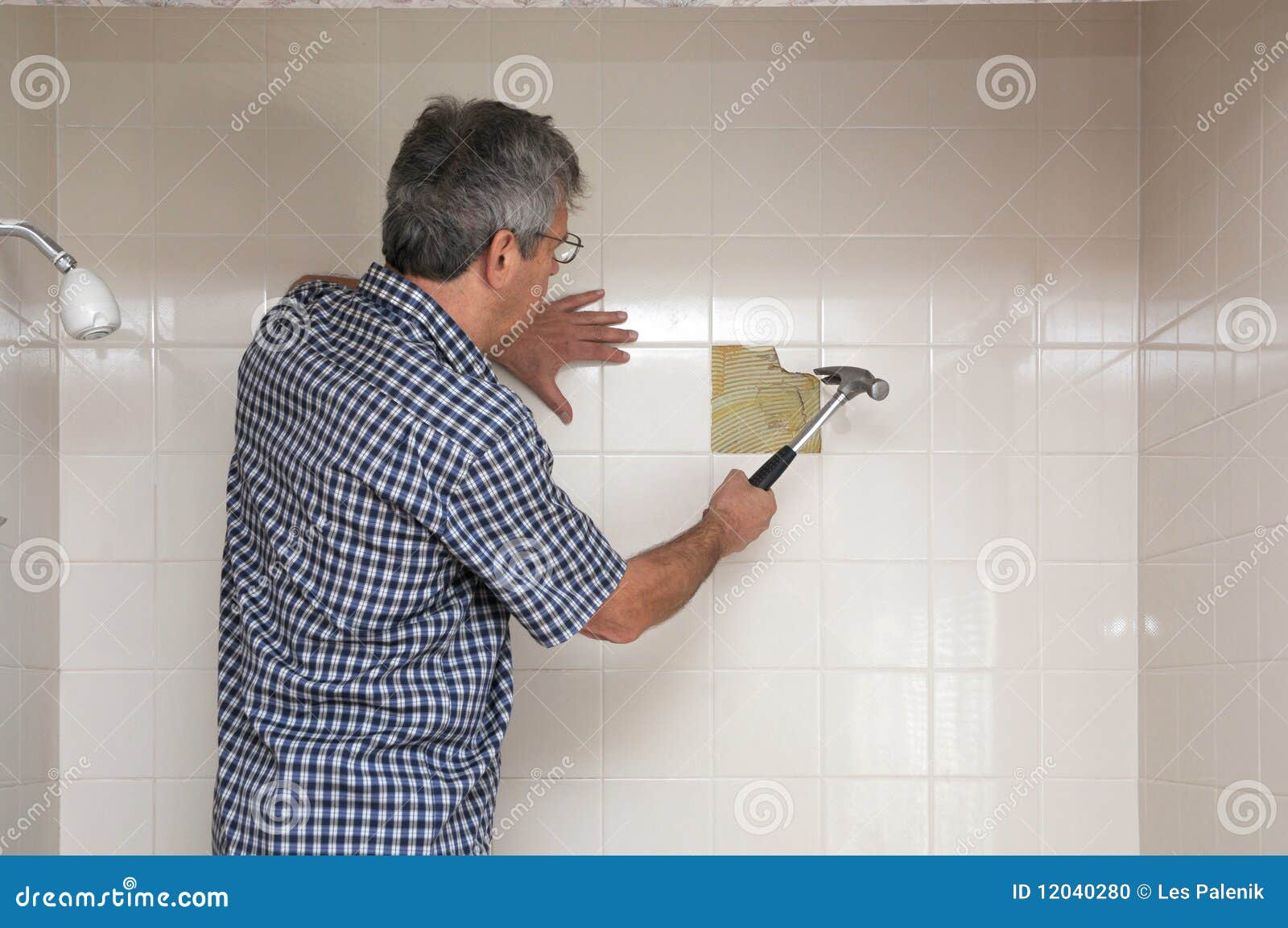 Man breaking up tiles stock photo. Image of wall, hammer 12040280