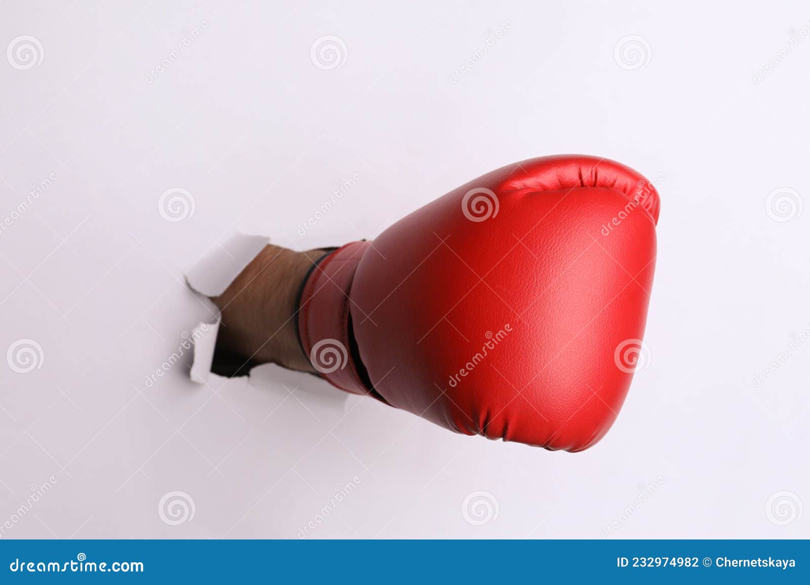 Man Breaking through White Paper with Boxing Glove, Closeup Stock Photo