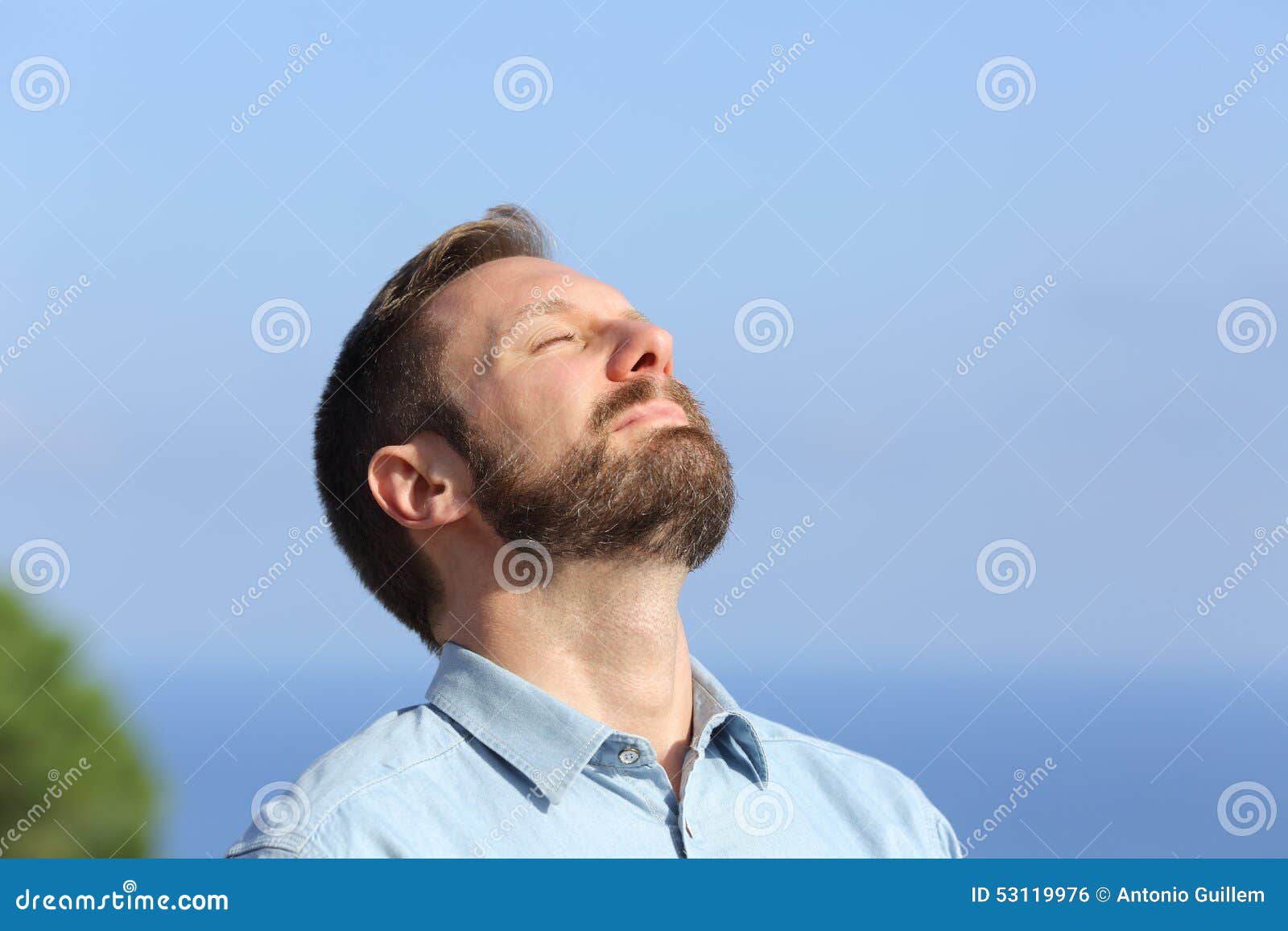 man breathing deep fresh air outdoors