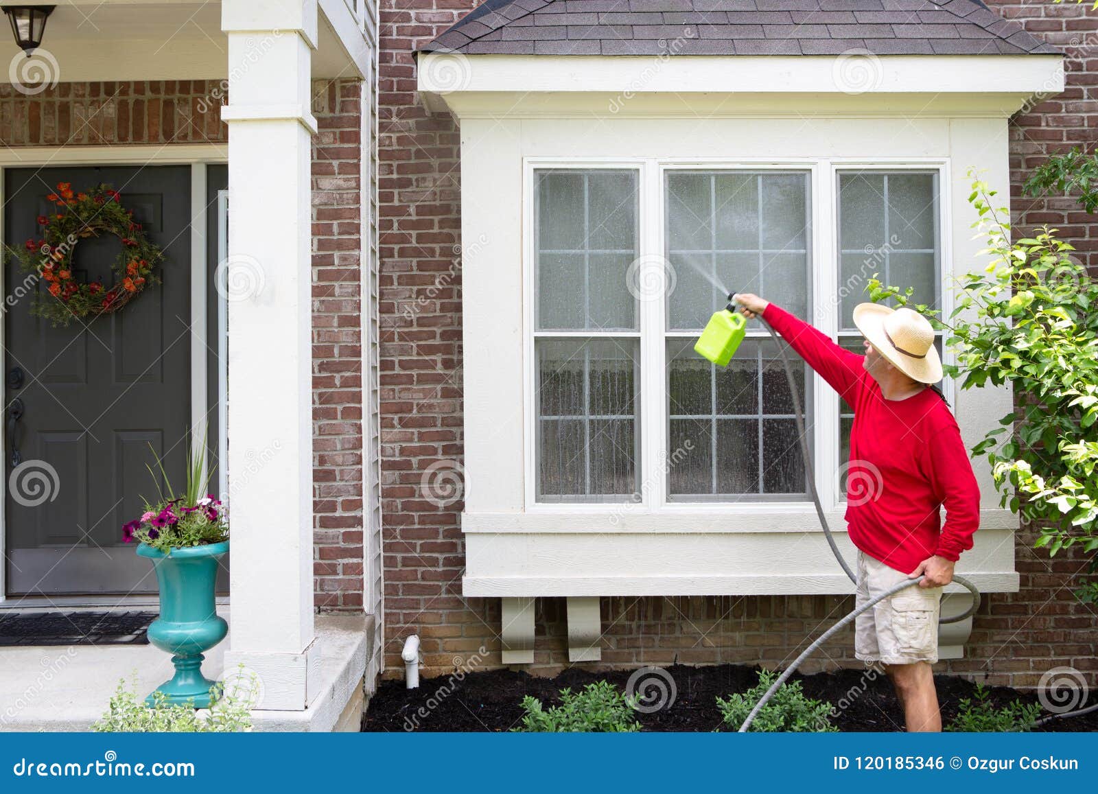 man washing the bump-out or bay windows