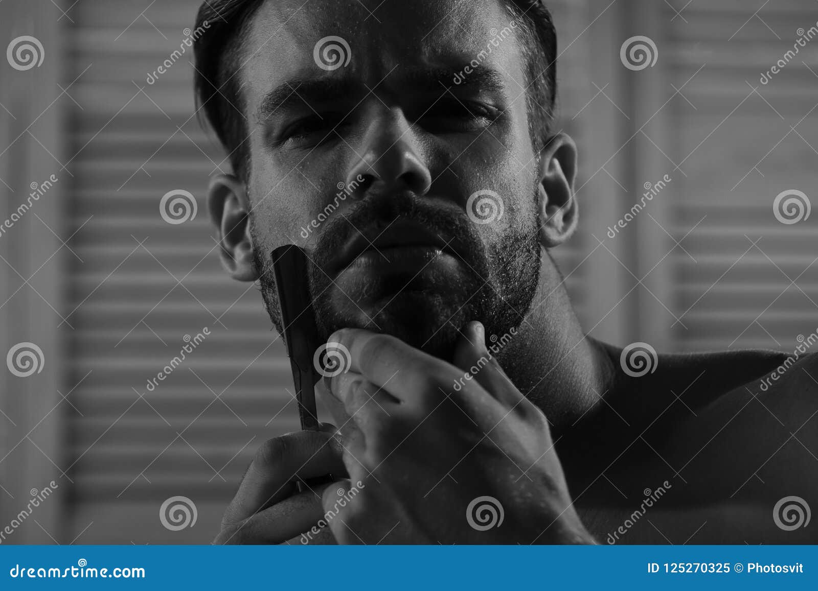 Man with Bristle and Concentrated Face on Vintage Wall Background, Selective Focus image
