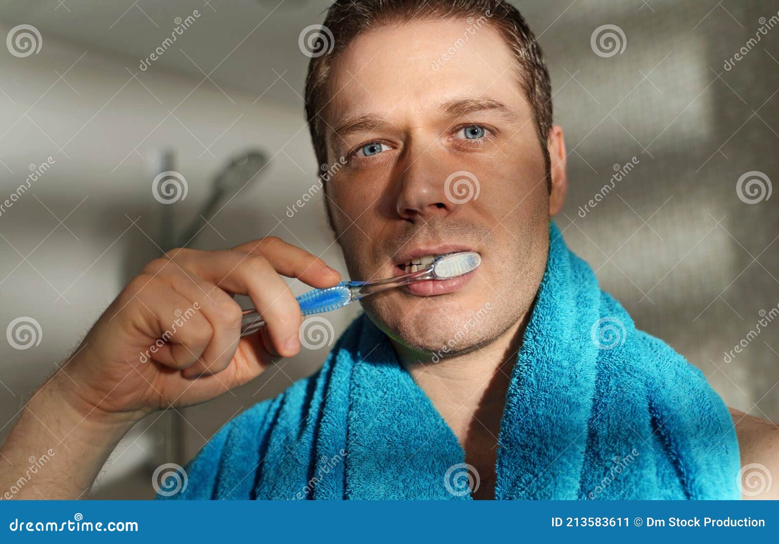 Man brushes his teeth stock image. Image of eyes, towel 213583611