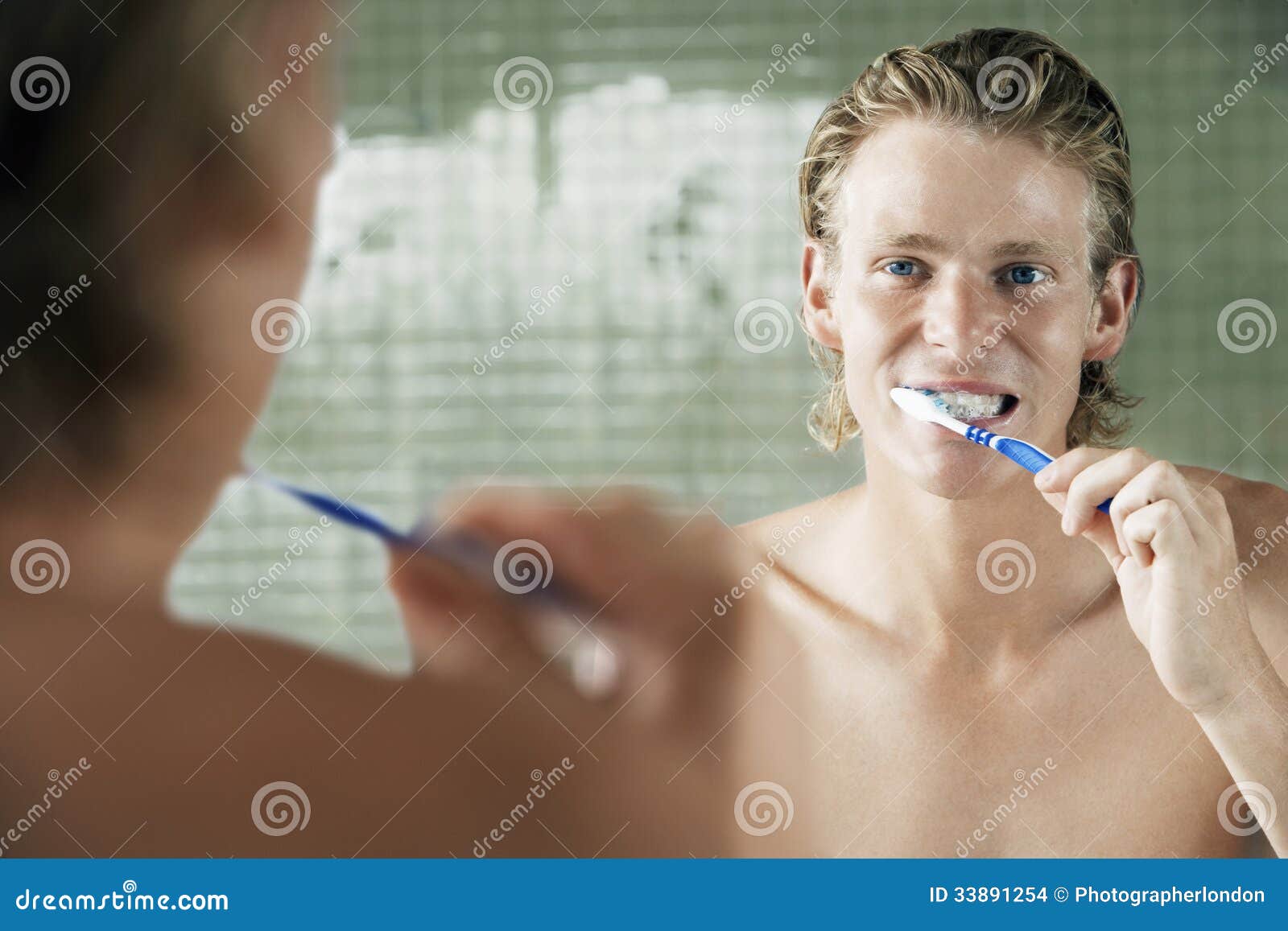 Man Brushing Teeth in Front of Mirror Stock Photo Image of face, hair