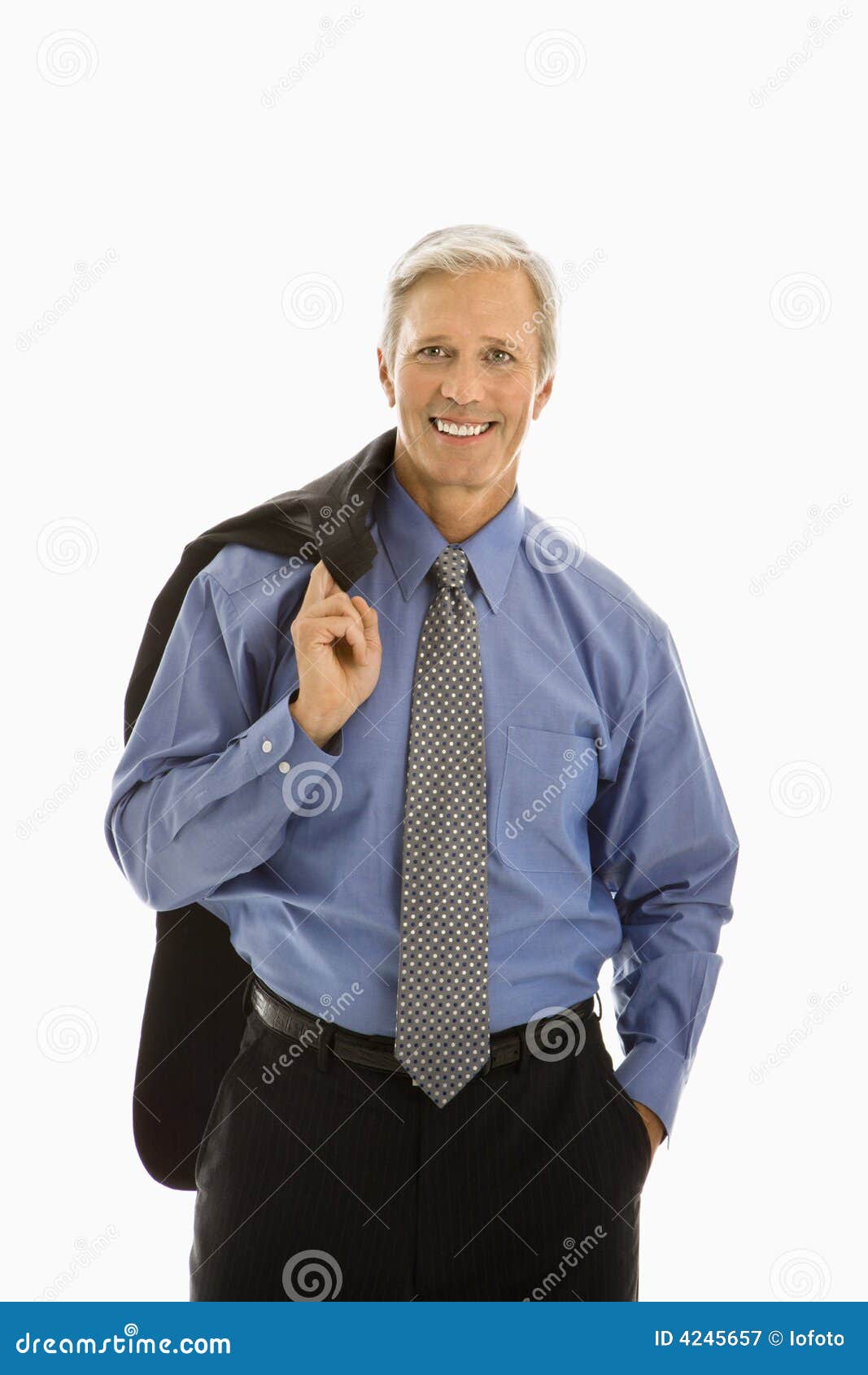 Man in business suit. Middle aged Caucasian man in business suit smiling at viewer with jacket draped over shoulder.