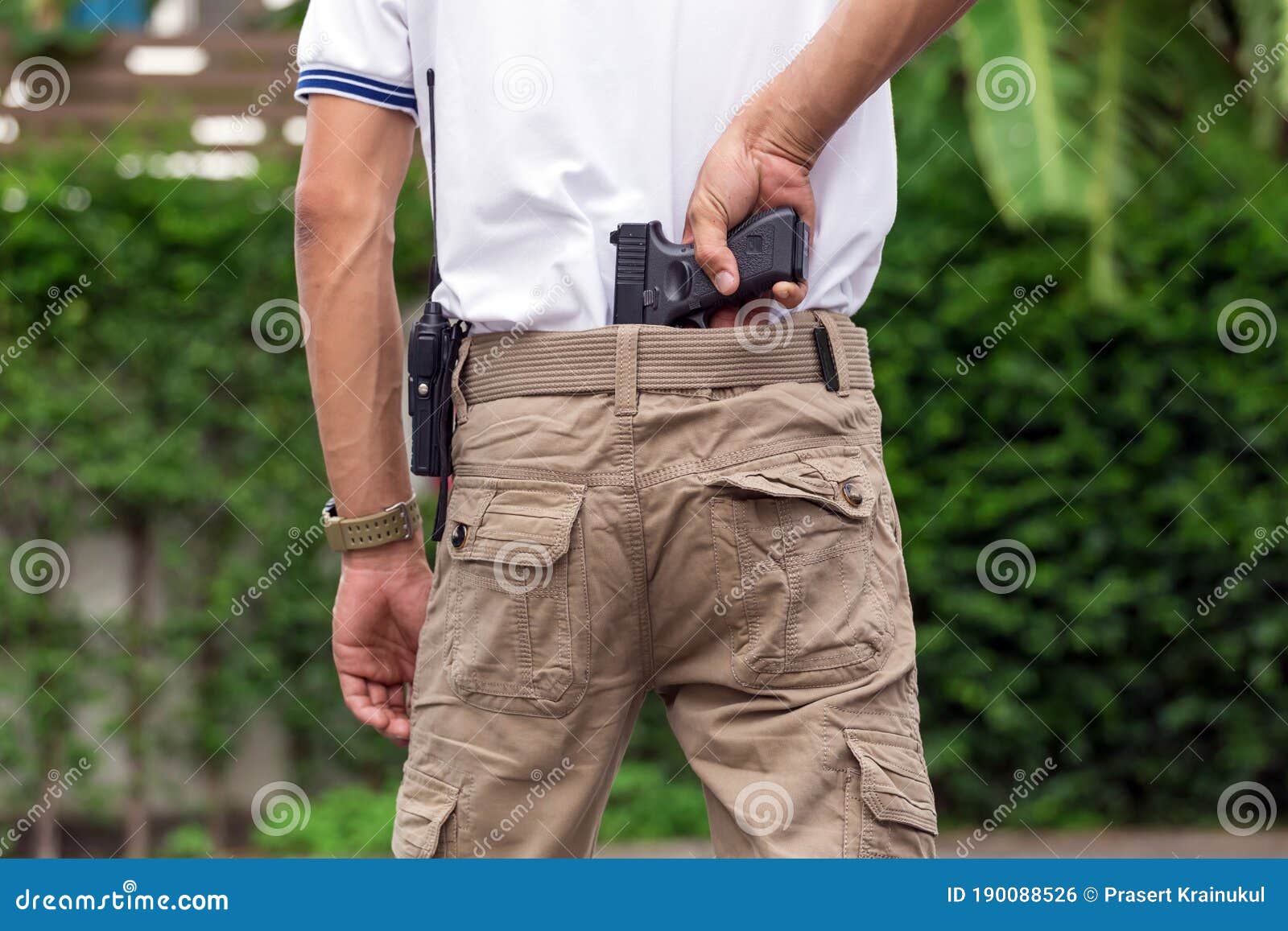 Man in Cargo Pants with Gun Stock Photo Image of cargo, hand 190088526