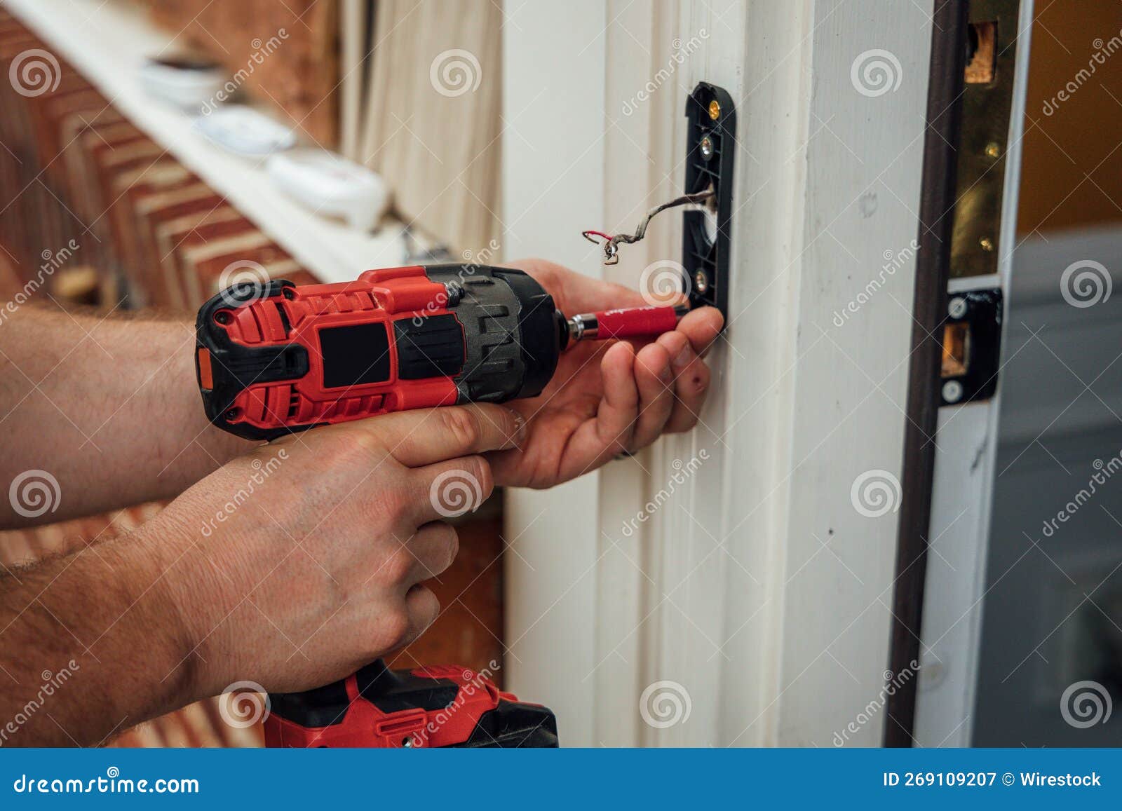 A Man Carpenter Fixing a Door Knob with a Drill Stock Image Image of