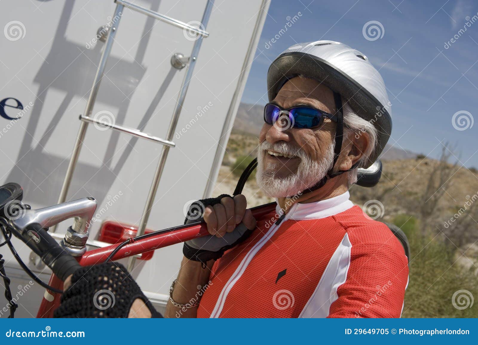 Man Carrying Bicycle on His Shoulder and Looking Away Stock Image