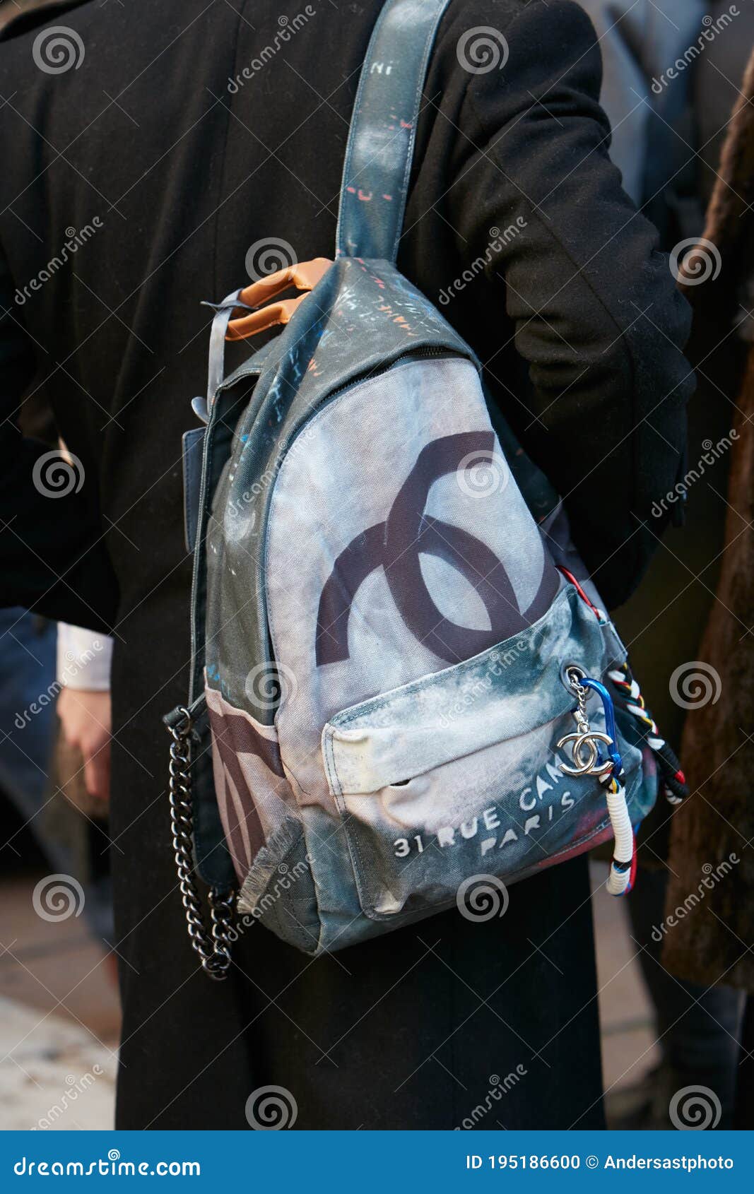 Man with Chanel Backpack before Salvatore Ferragamo Fashion Show