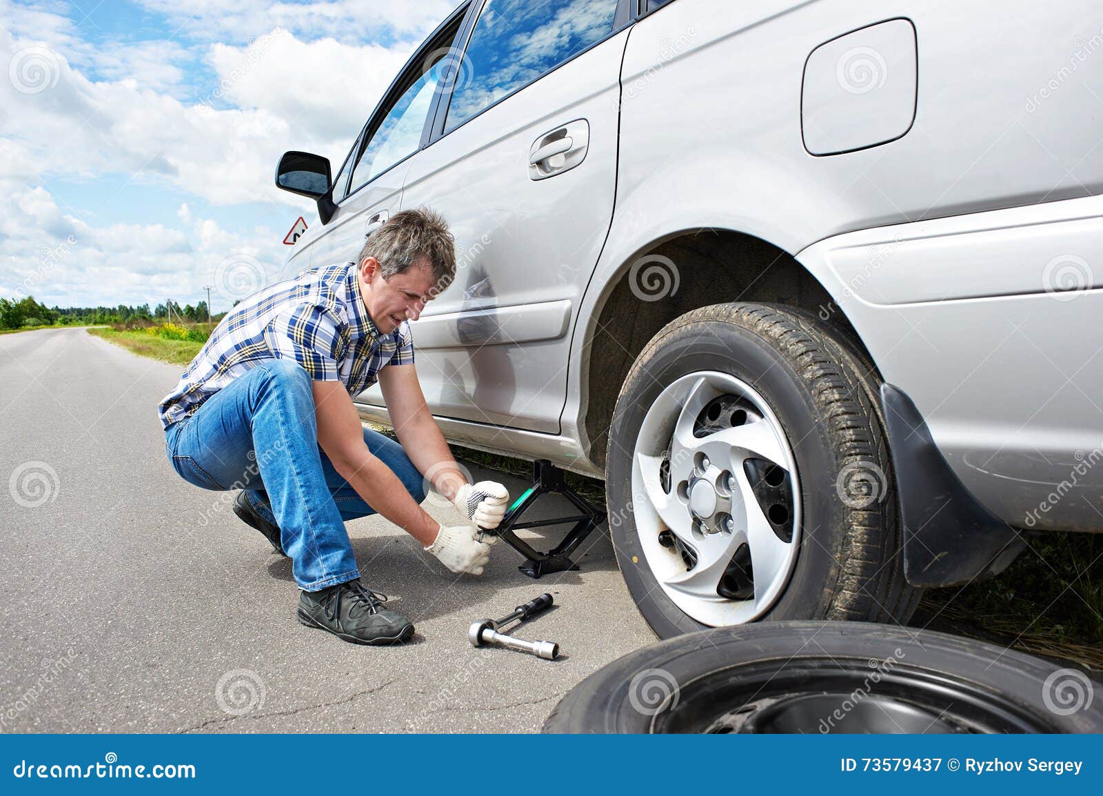 Man Changing a Spare Tire of Car Stock Image Image of replacement