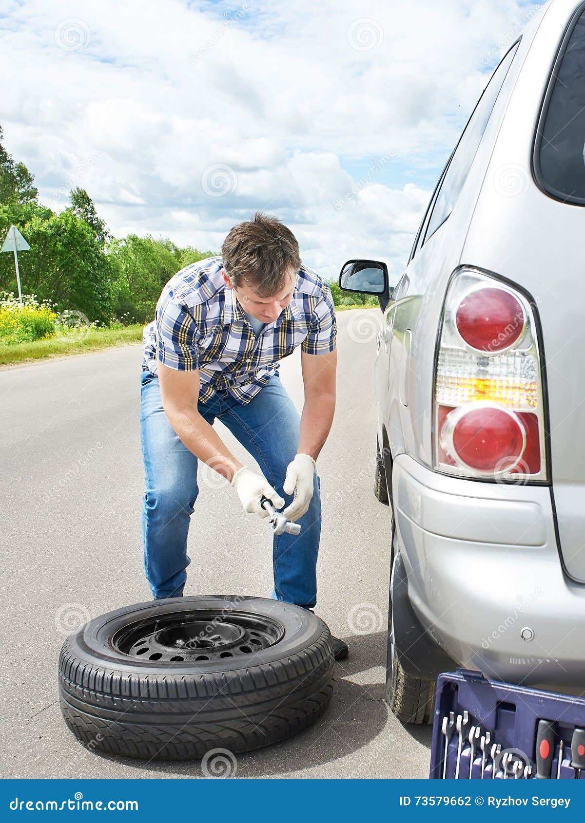 Man Changing a Spare Tire of Car Stock Photo Image of auto, transport