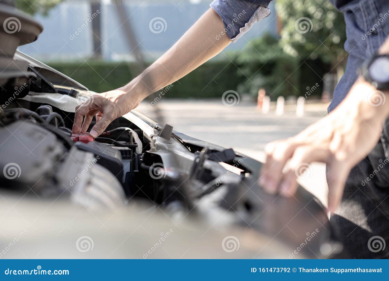 A Man Checking Car Engine, Check and Maintenance the Battery in Car