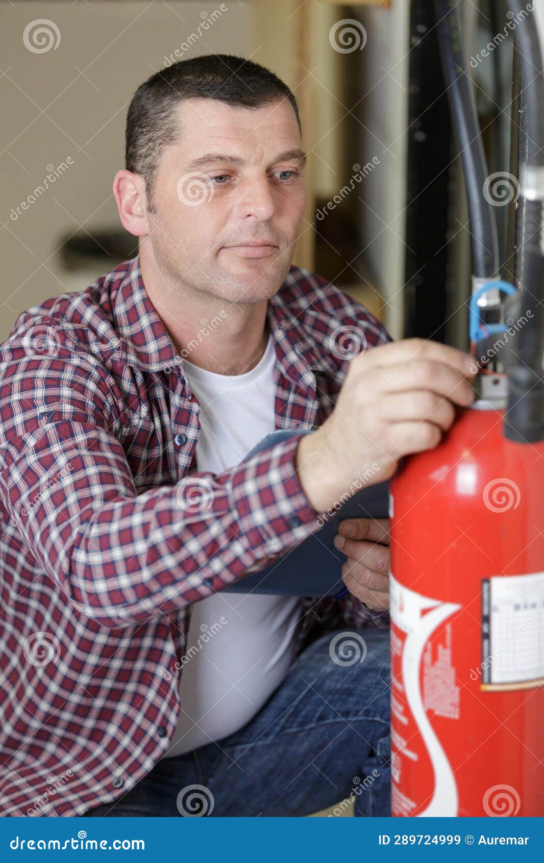 Man Checking Fire Extinguisher Writing on Document Stock Image Image of inspecting, spray