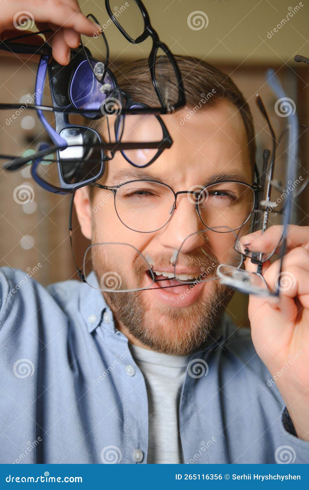 Man is Choosing Glasses in Optics Store. Stock Photo Image of