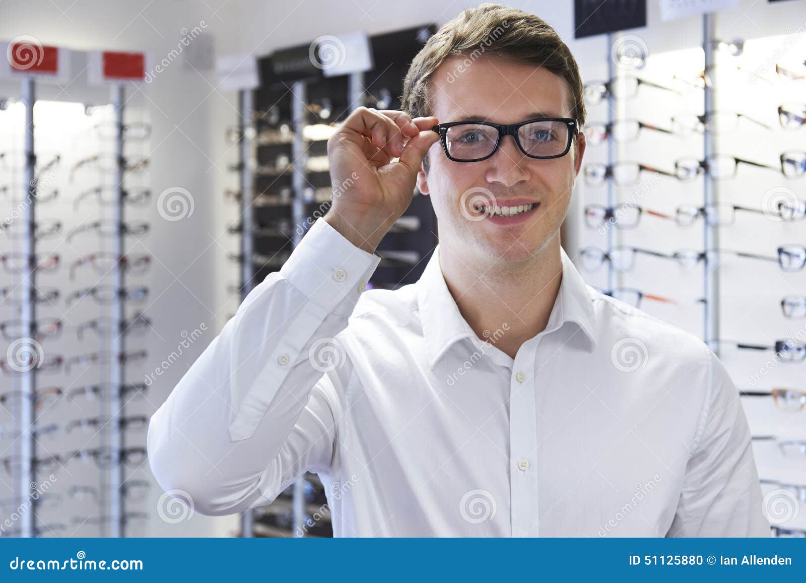 Man Choosing New Glasses at Opticians Stock Photo - Image of display ...