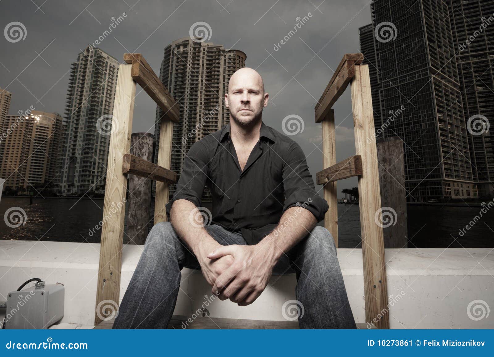 Man with the city in the background. Handsome man posing with the city in the background