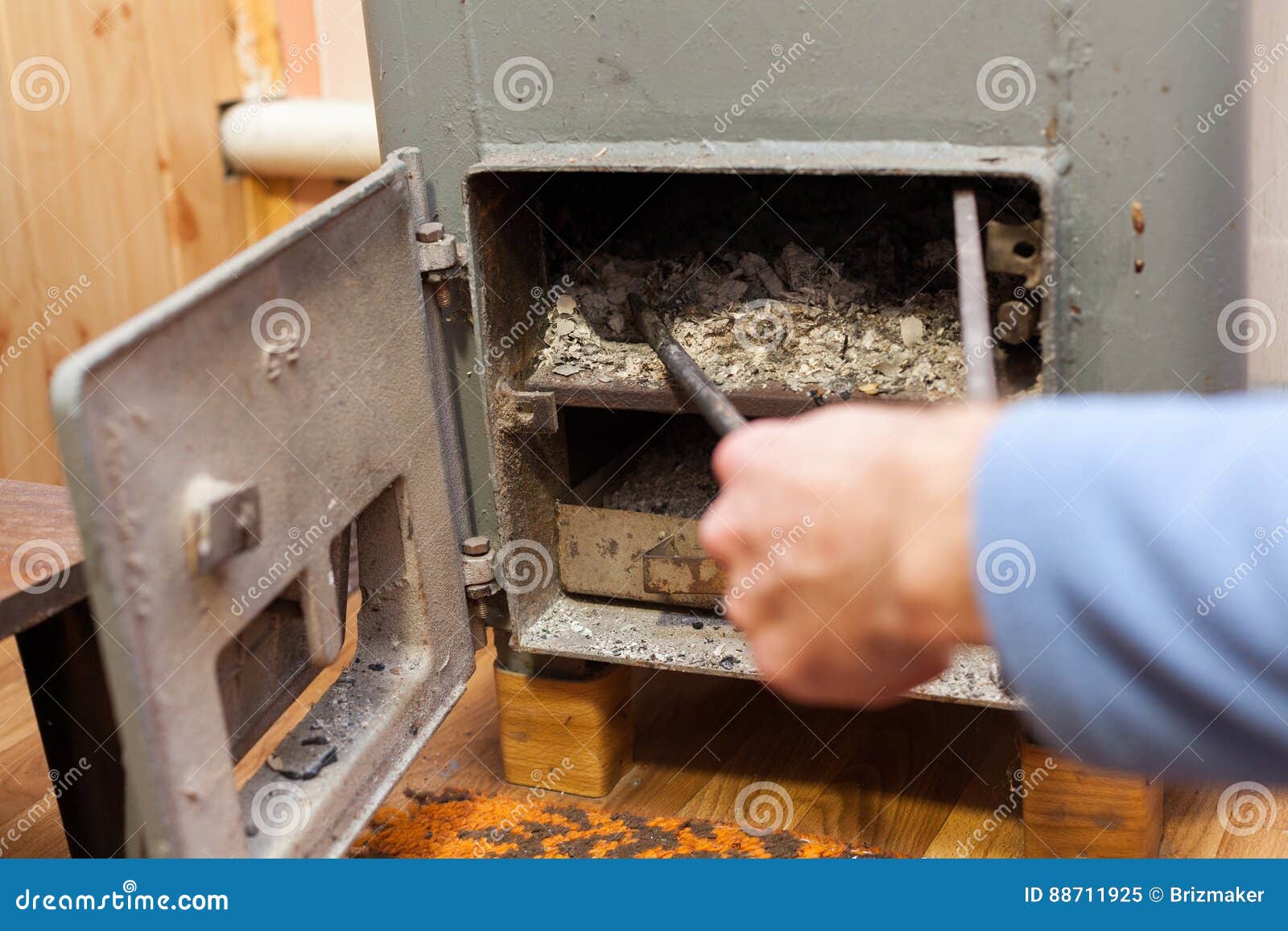 Man Clean Burn Wood Coals of Fire in Solid Bio Fuel Boiler. Stock Image Image of ecological
