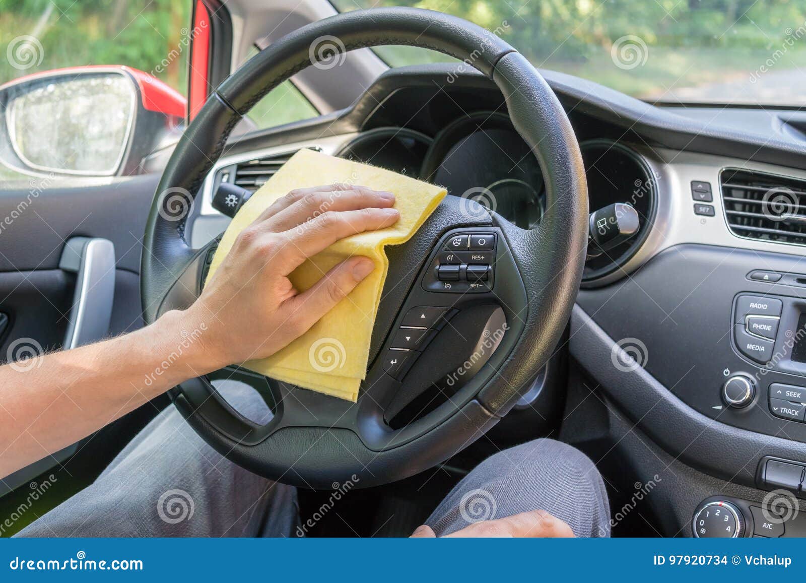 Man is Cleaning Car Wheel and Dashboard with Microfiber Cloth Stock