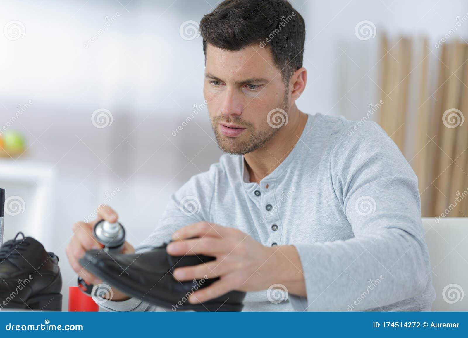 Man cleaning combat shoes stock photo. Image of holding 174514272
