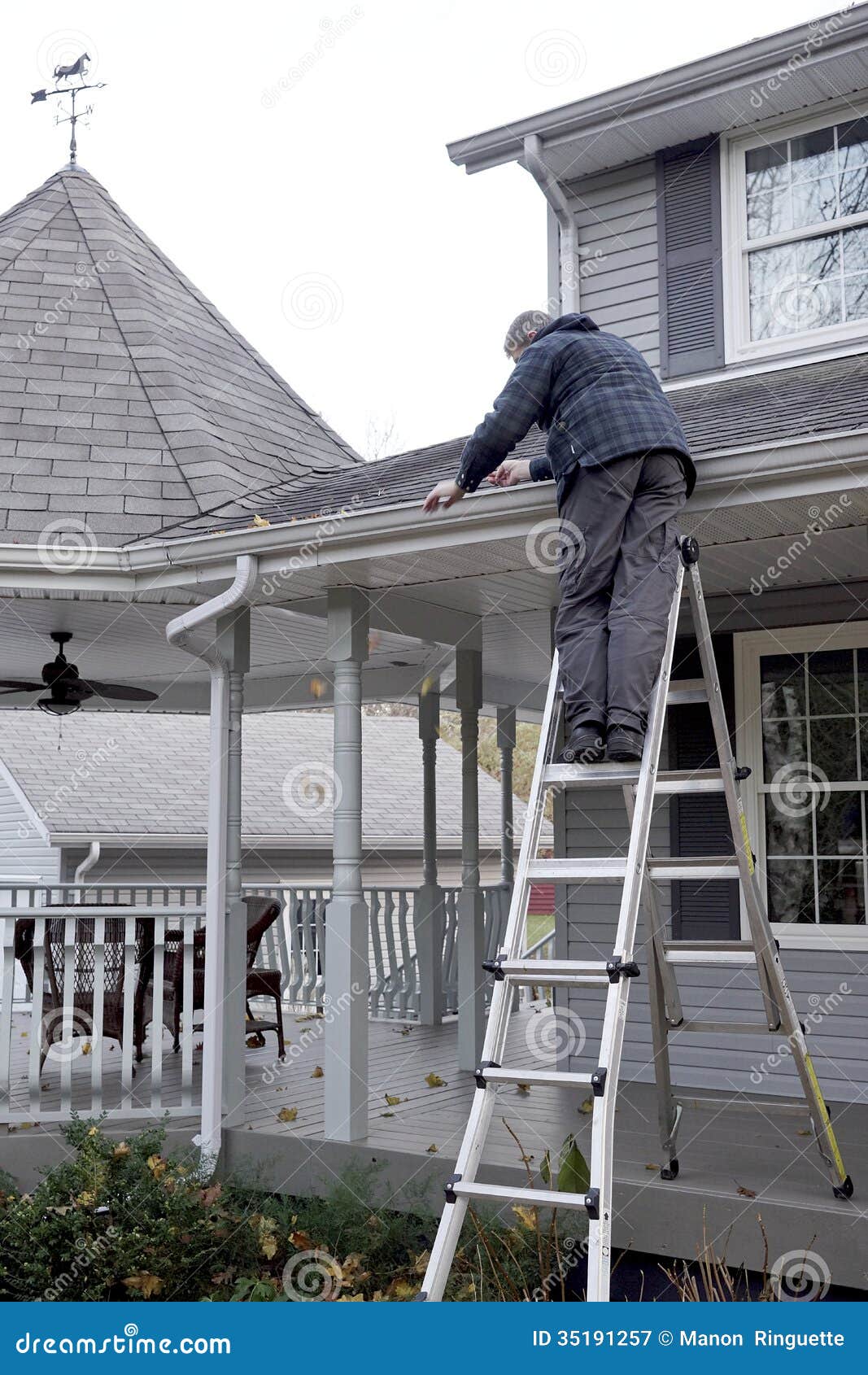 man cleaning eaves troughs