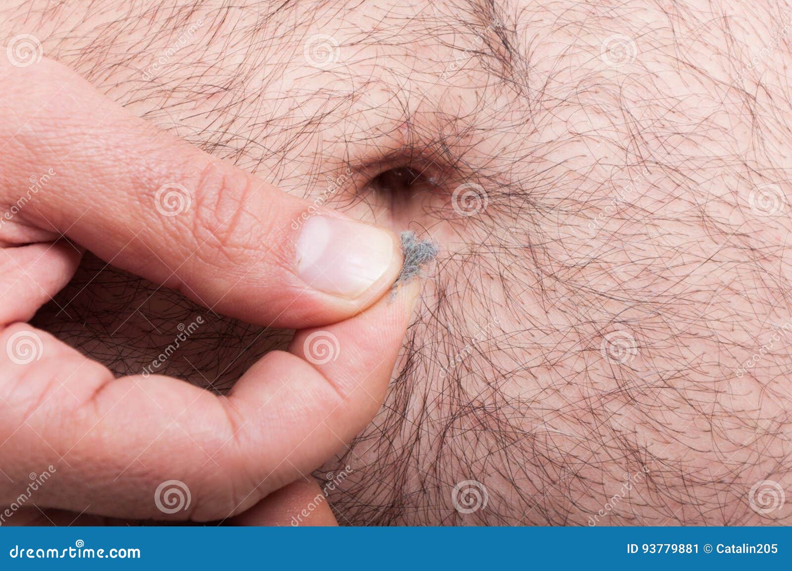 man cleaning his belly of the lint or fuzz