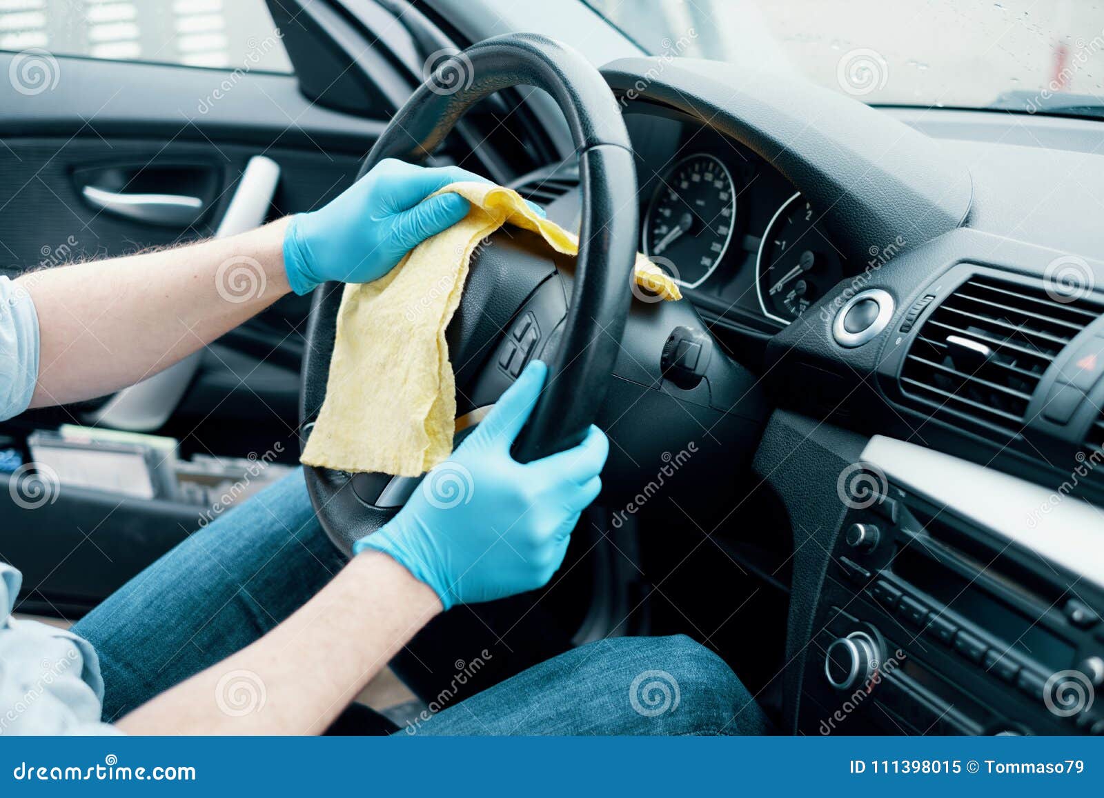 Man Cleaning His Car Interiors And Dashboard Wheel From Dust