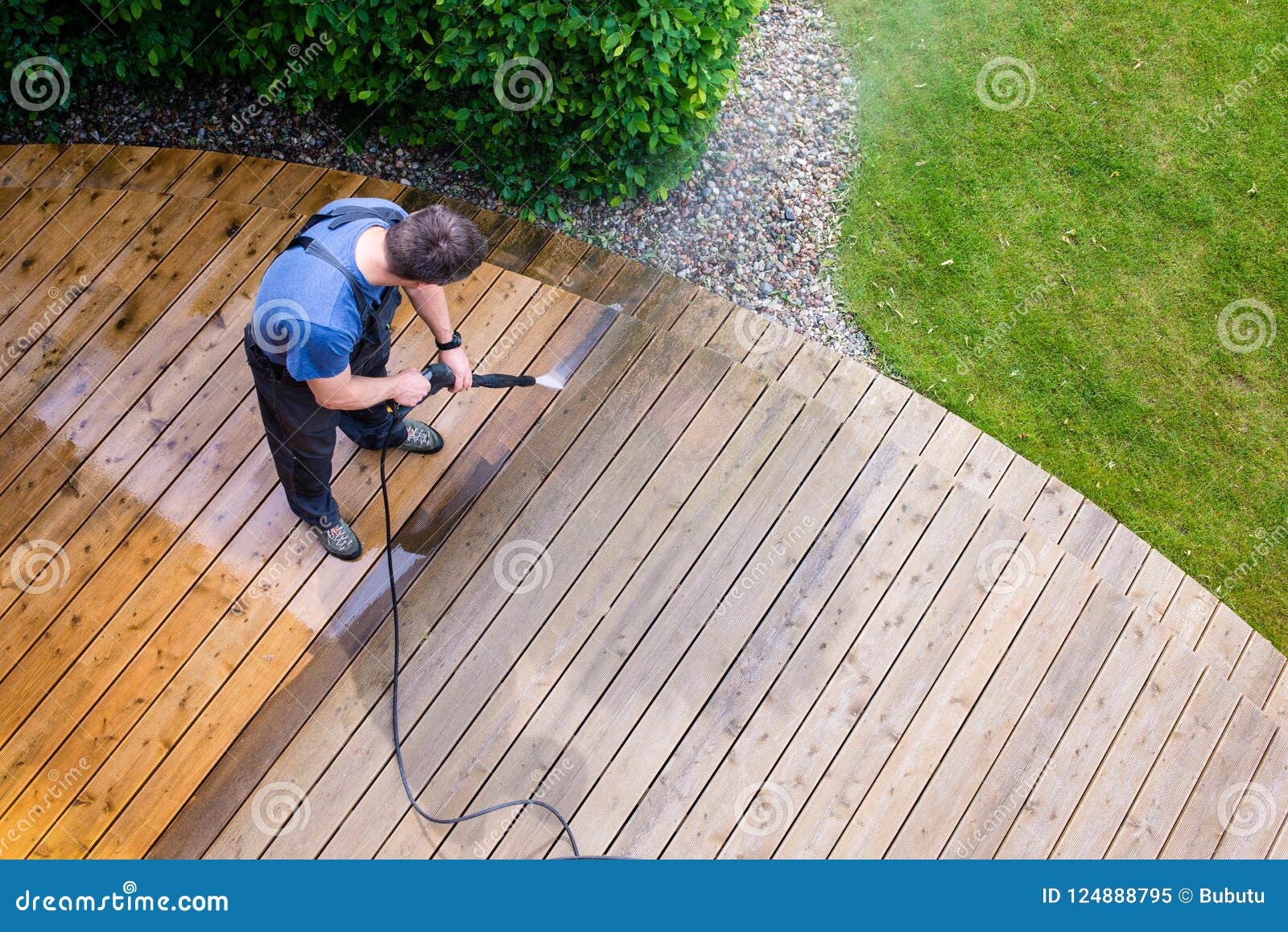 man cleaning terrace with a power washer - high water pressure c