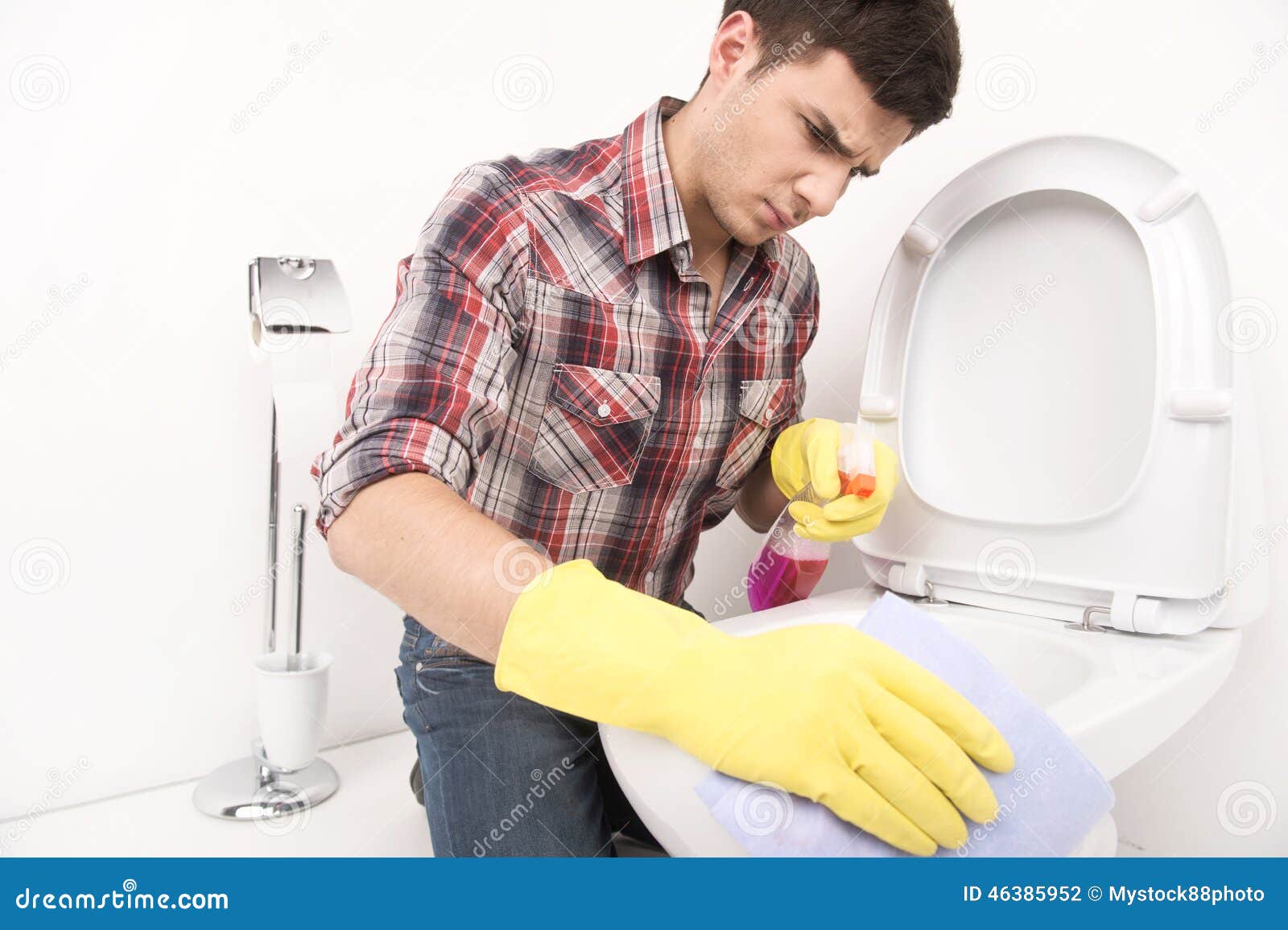 Man Cleaning  Toilet  With Spray Cleaner Stock Photo 
