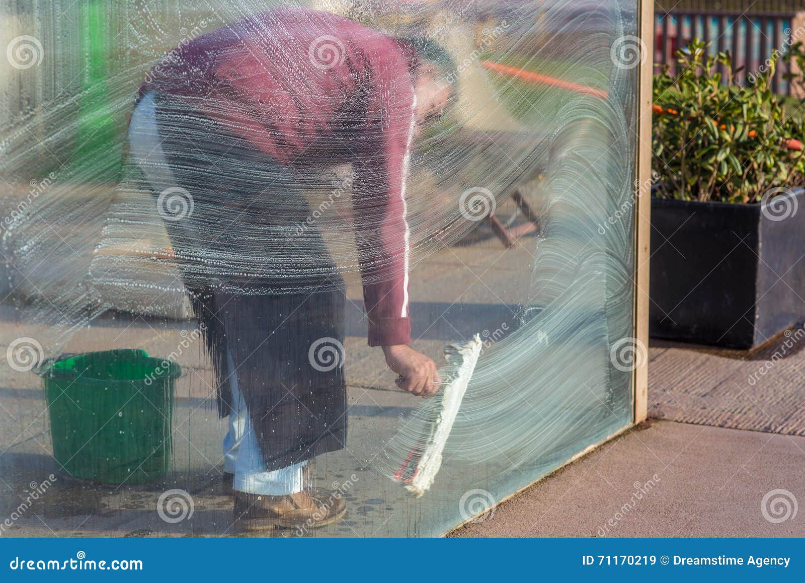 man cleaning windows glass pane with foam