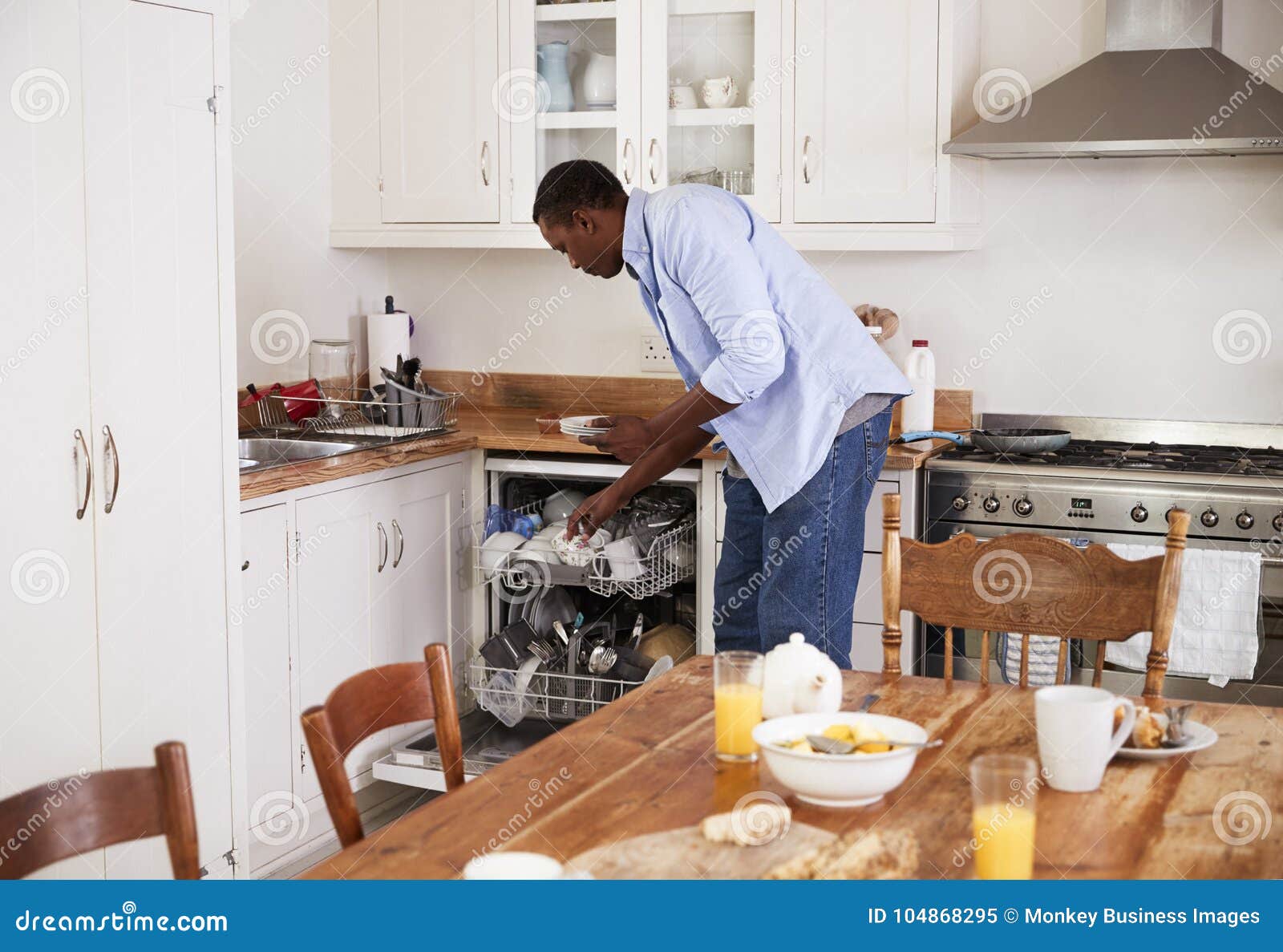 Man Clearing Breakfast Table and Loading Dishwasher Stock Image Image of people, wiping 104868295