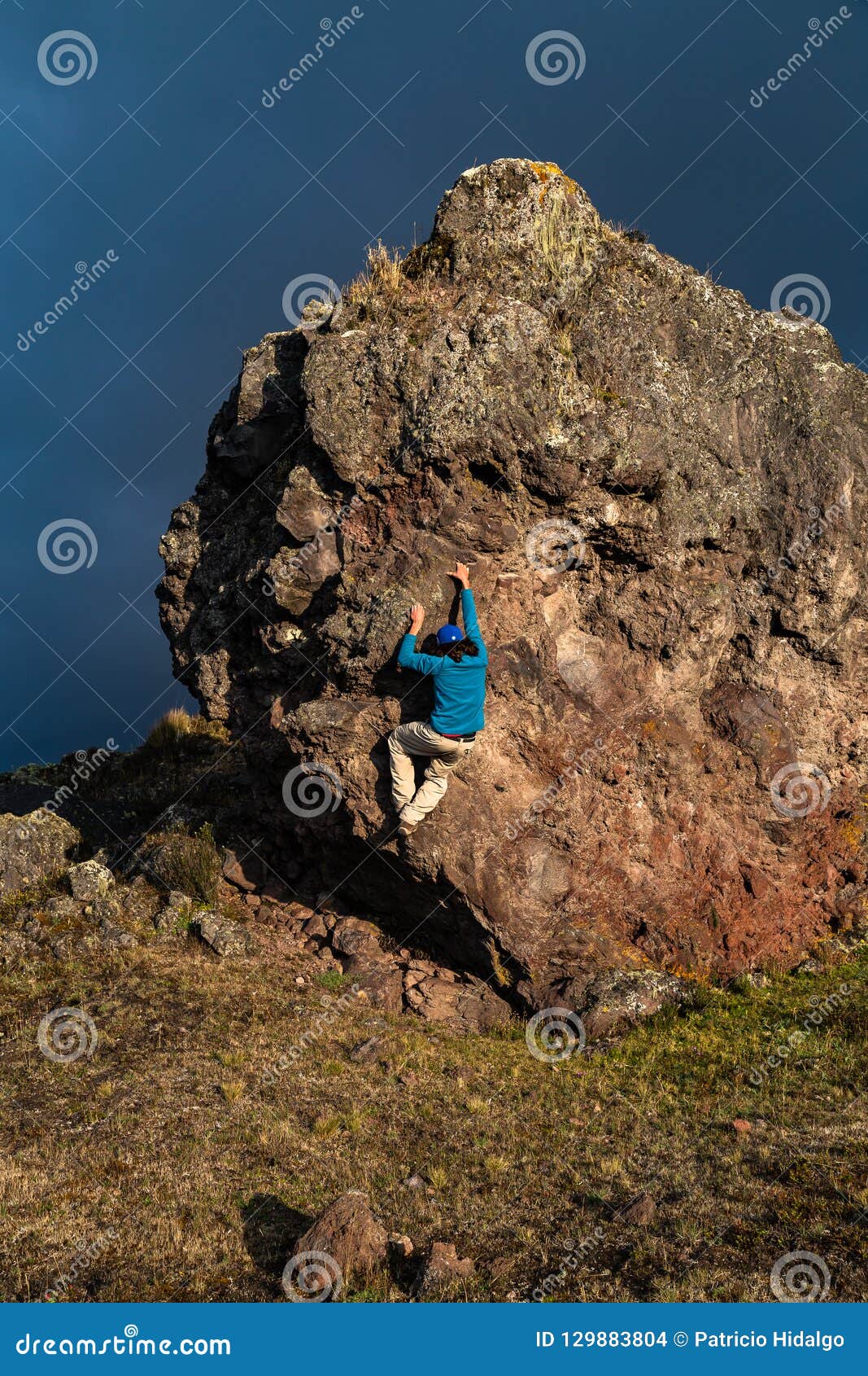 Man climbing a rock stock photo. Image of shadow, effort 129883804