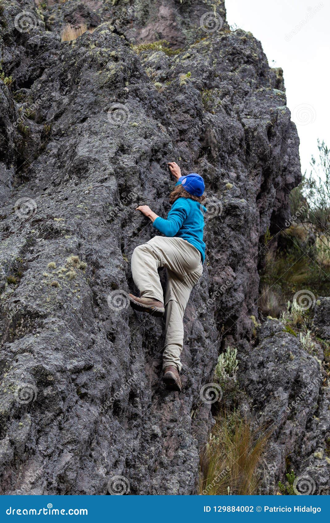 Man climbing a rock stock photo. Image of person, turquoise 129884002