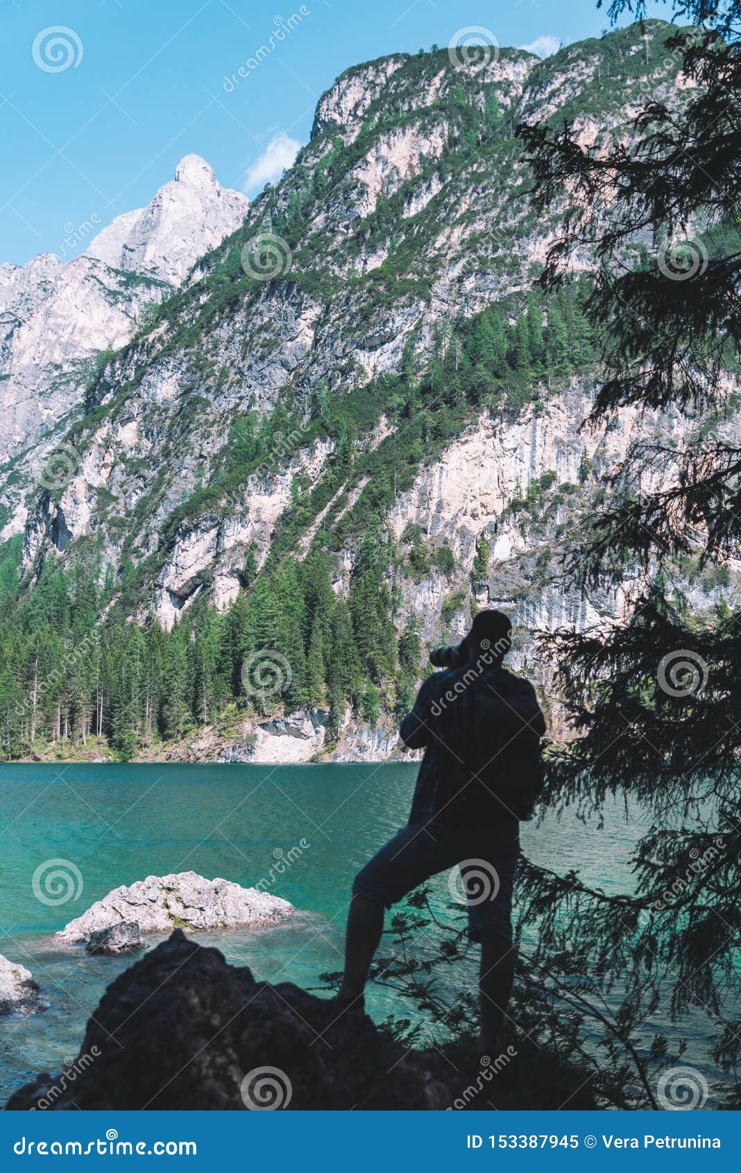 Man Climbing by Rocks To Shoot Beautiful Landscape of Lake and ...