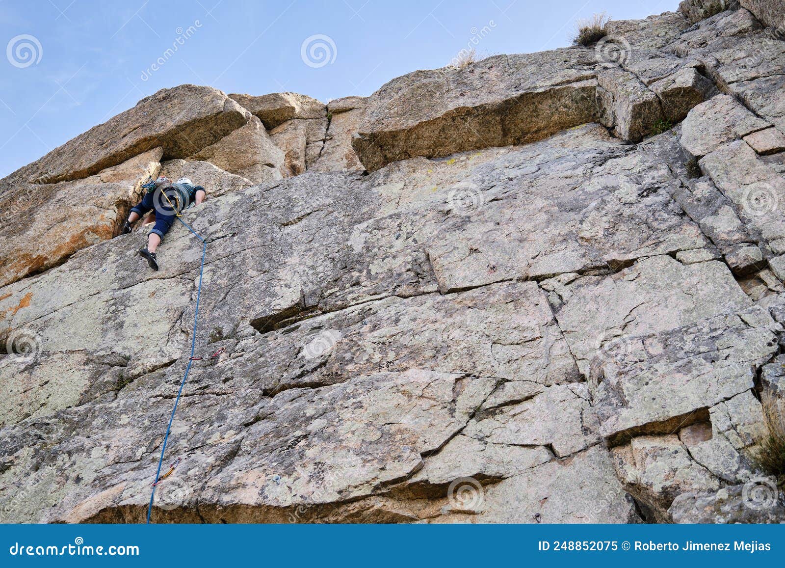 Man Climbing Up a Vertical Rock Wall. Stock Image Image of mature