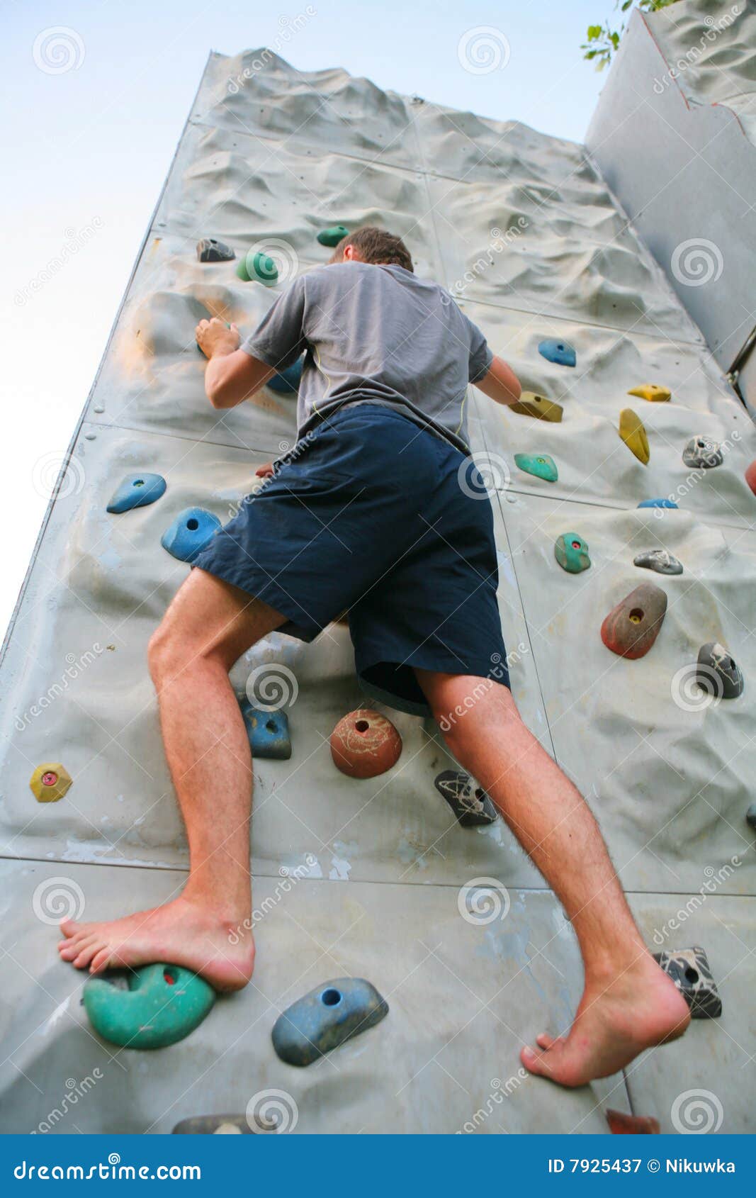 Man climbing a wall stock image. Image of feet, person 7925437