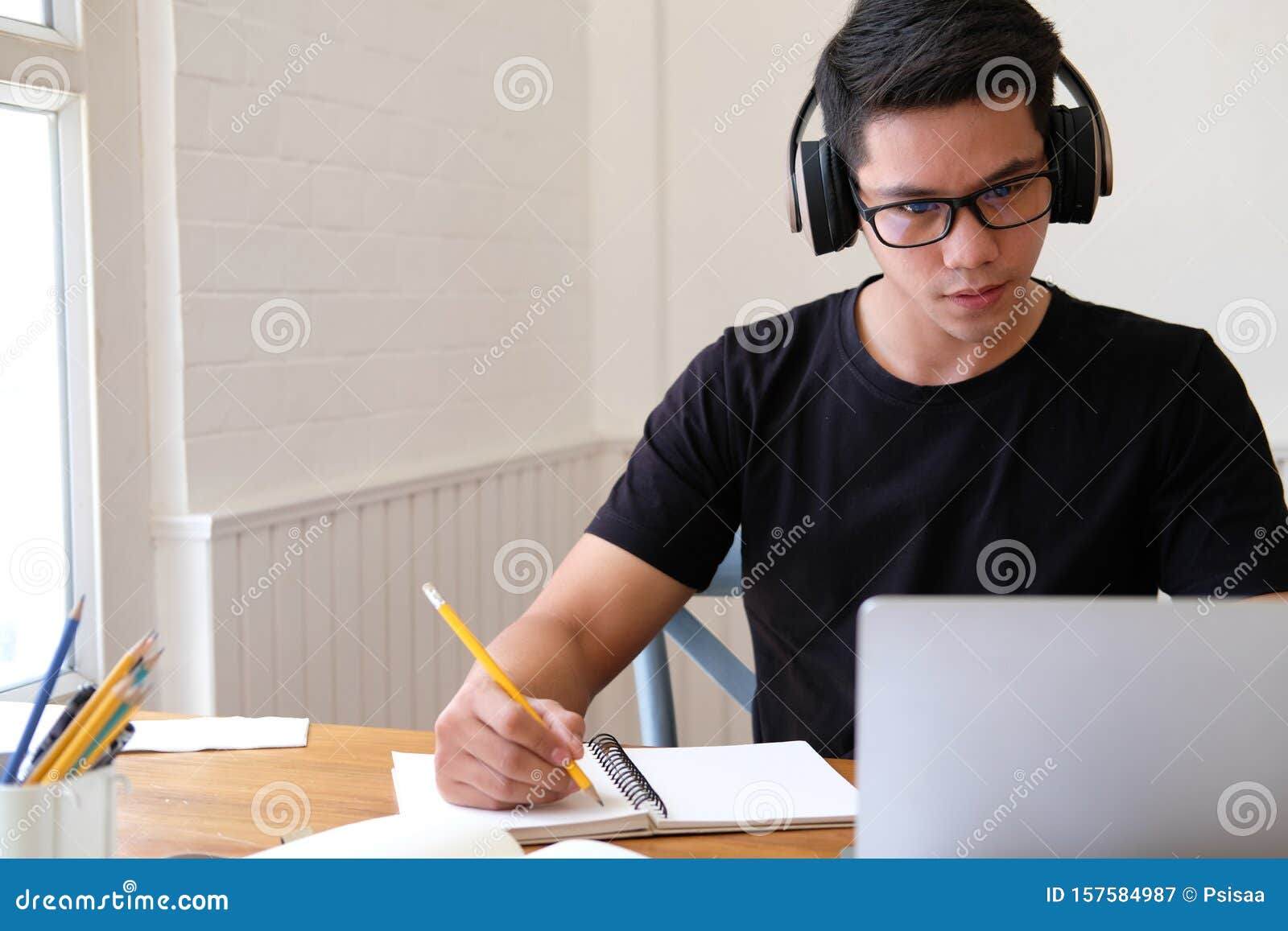 man college student  studying learning lesson with computer online taking note