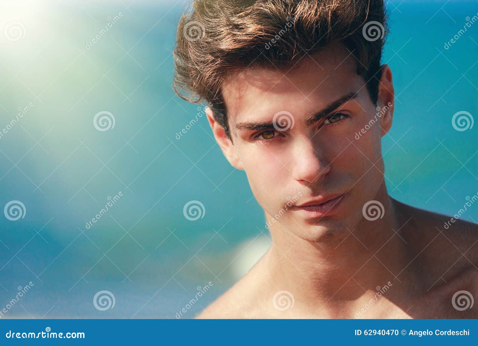 man confident gaze, handsome face model. hair style. blue background
