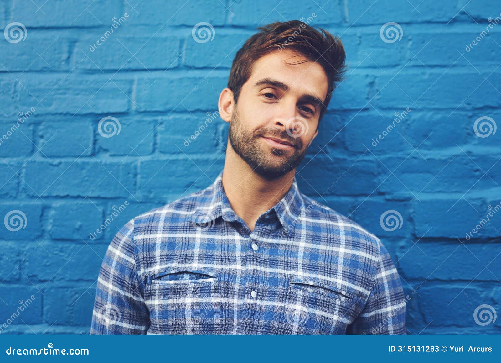 man, confident in portrait and relax on wall background, casual fashion and positivity with blue aesthetic. cool smirk